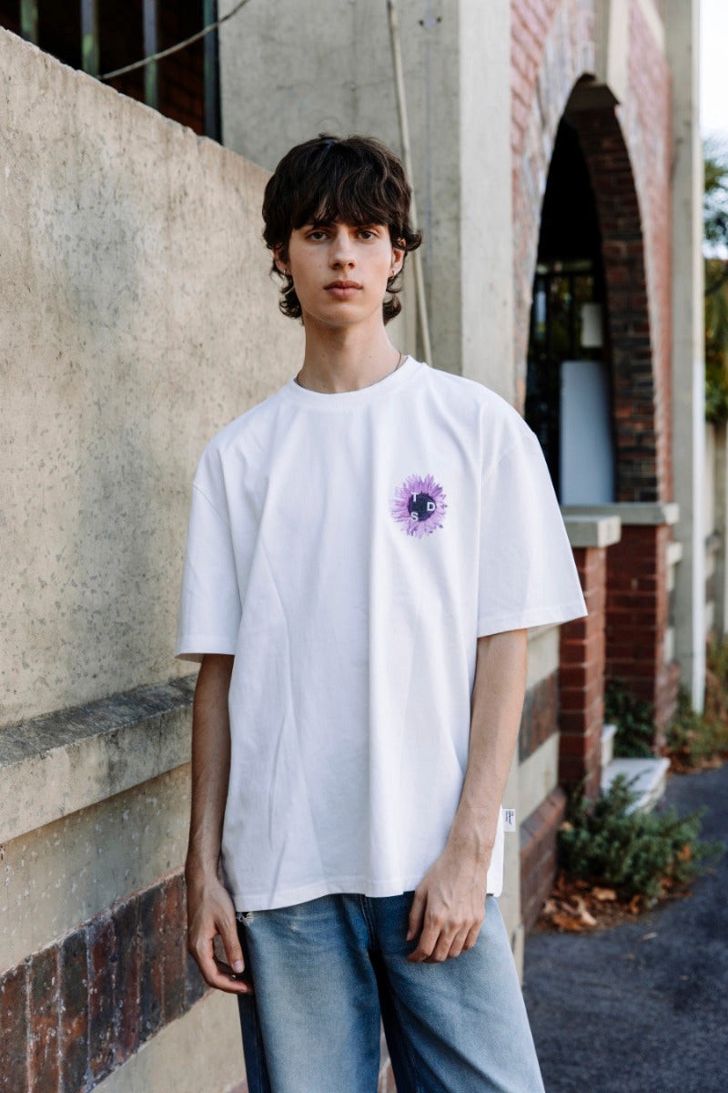 Young man wearing The Different Society Purple Sunflower t-shirt in the colour white