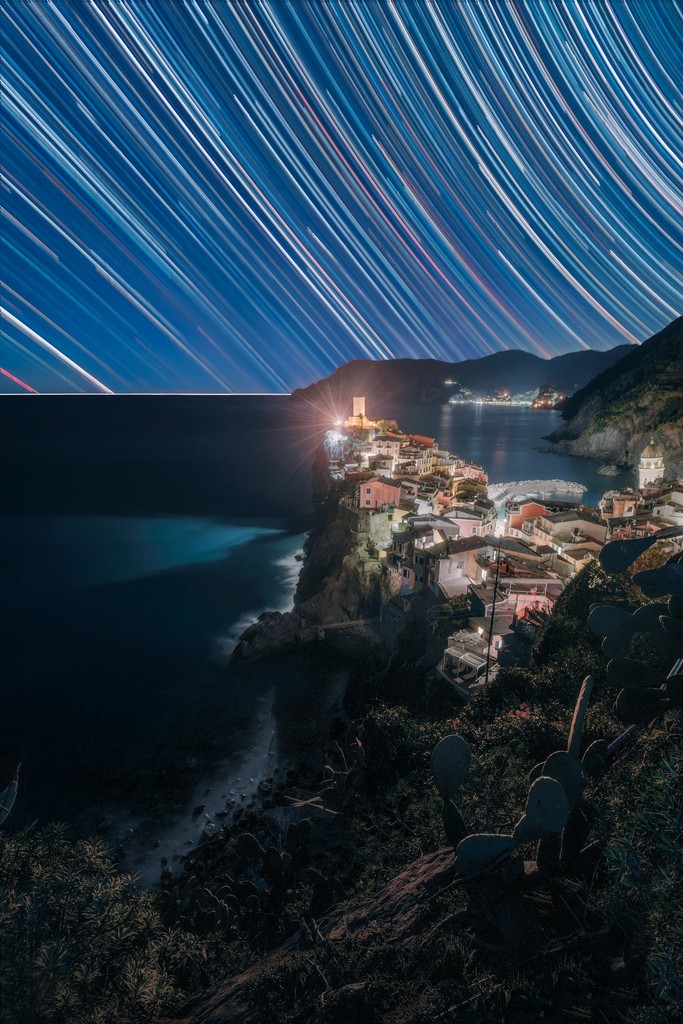 A beautiful Italian city at night with star trails in the background