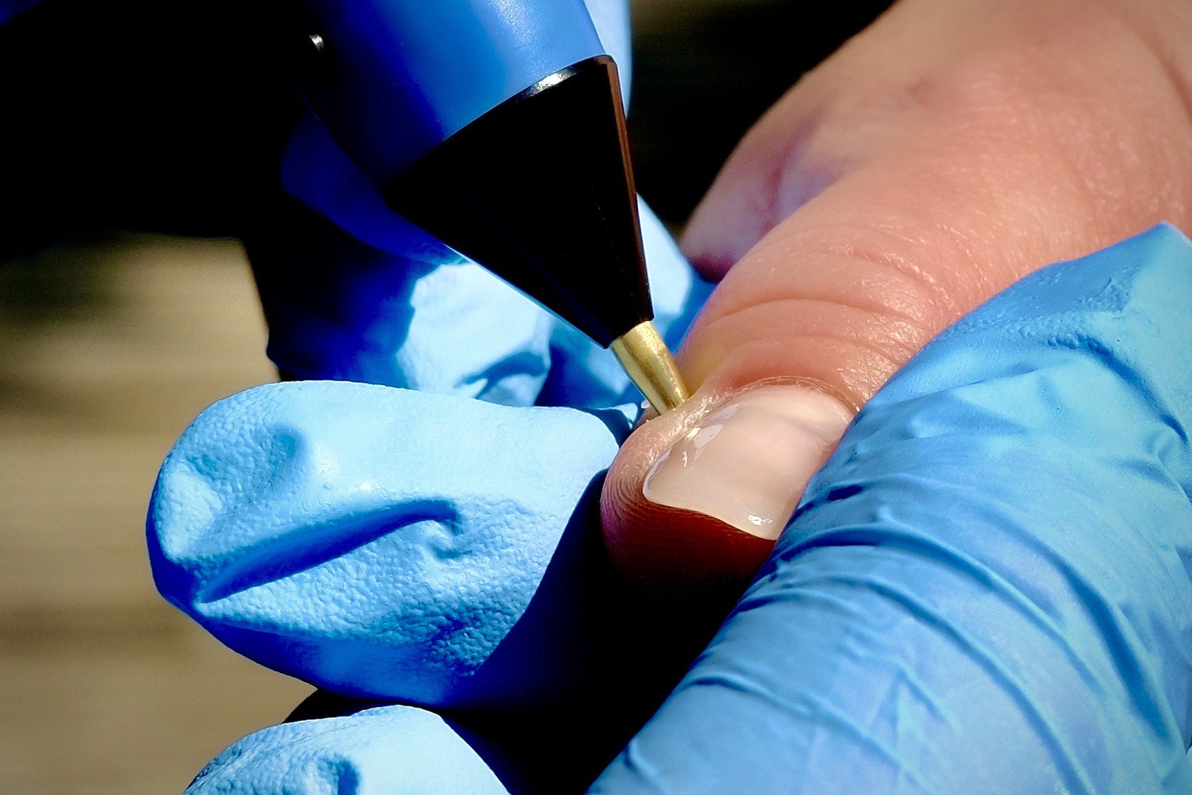 A serene and elegant spa space with wooden reclining chairs and white cushions. Golden sunlight filters through a cascading water feature, creating a peaceful atmosphere. Tropical plants and candles add to the relaxing ambiance.