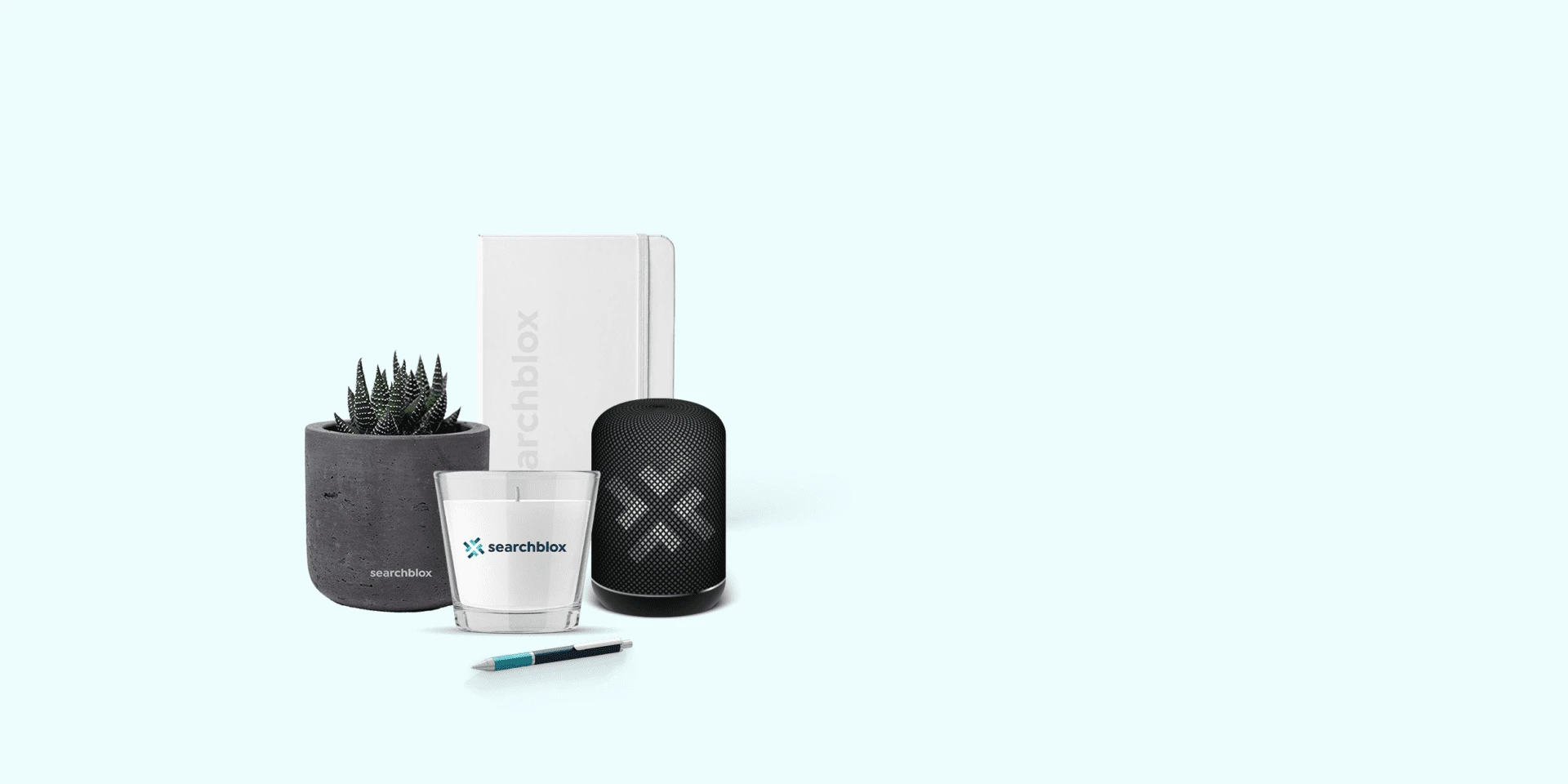 SearchBlox-branded merchandise: notebook, candle glass, speaker, plant pot and pen