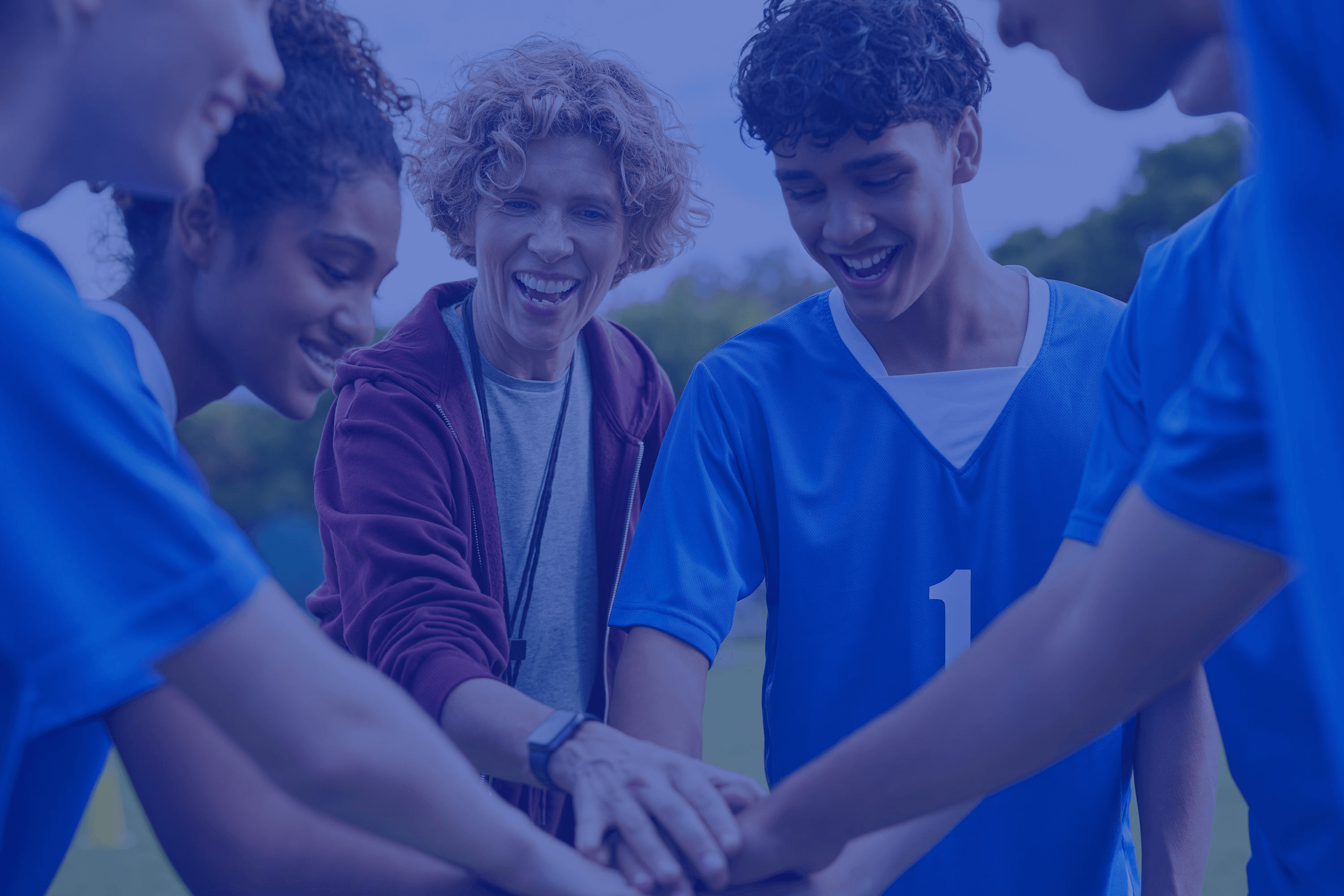 Youth sports players huddling together, representing the teamwork behind TeamLinkt's dedicated migration support