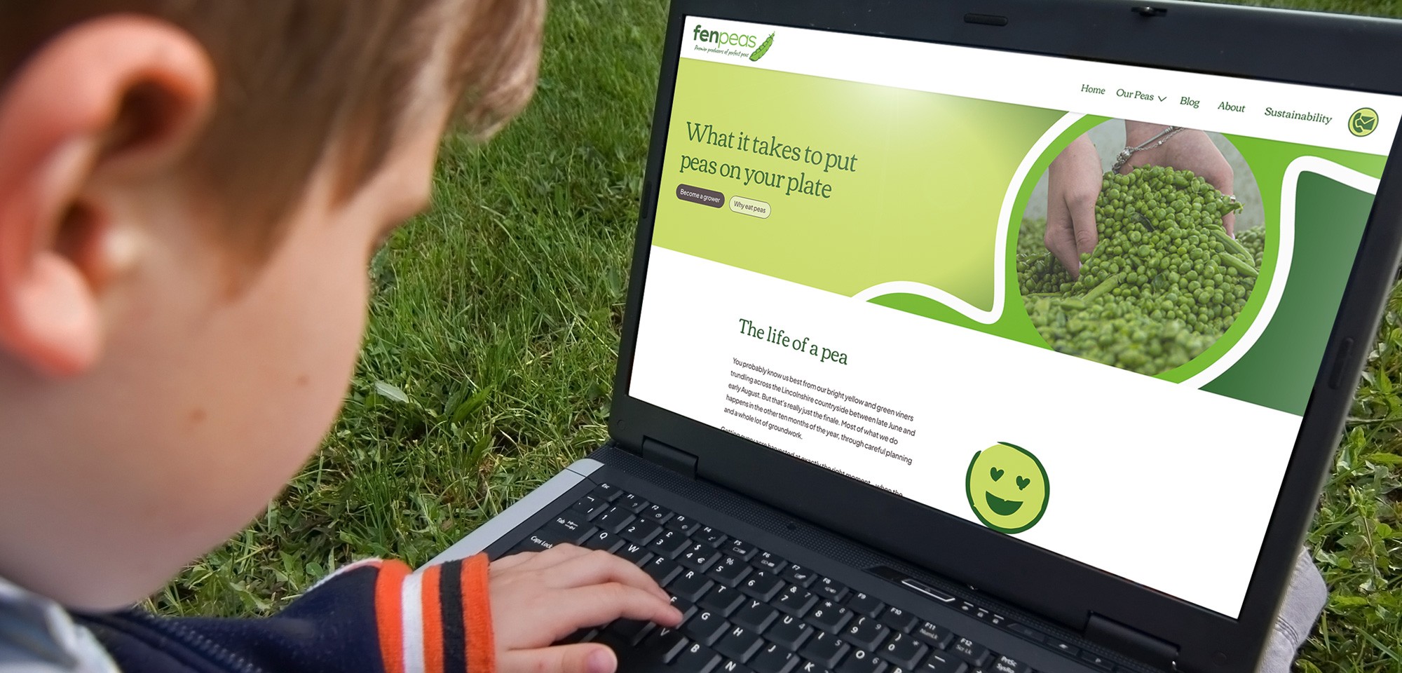 Child using a laptop on the grass, viewing the new Fen Peas website's "Our Peas" page with the headline "What it takes to put peas on your plate