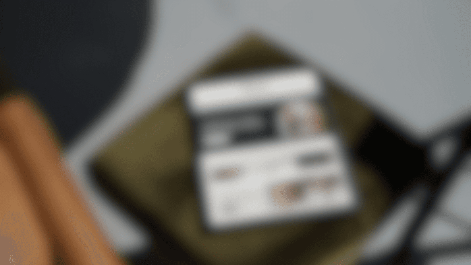 Blurred close-up of a green parrot with yellow and orange feathers, water droplets.