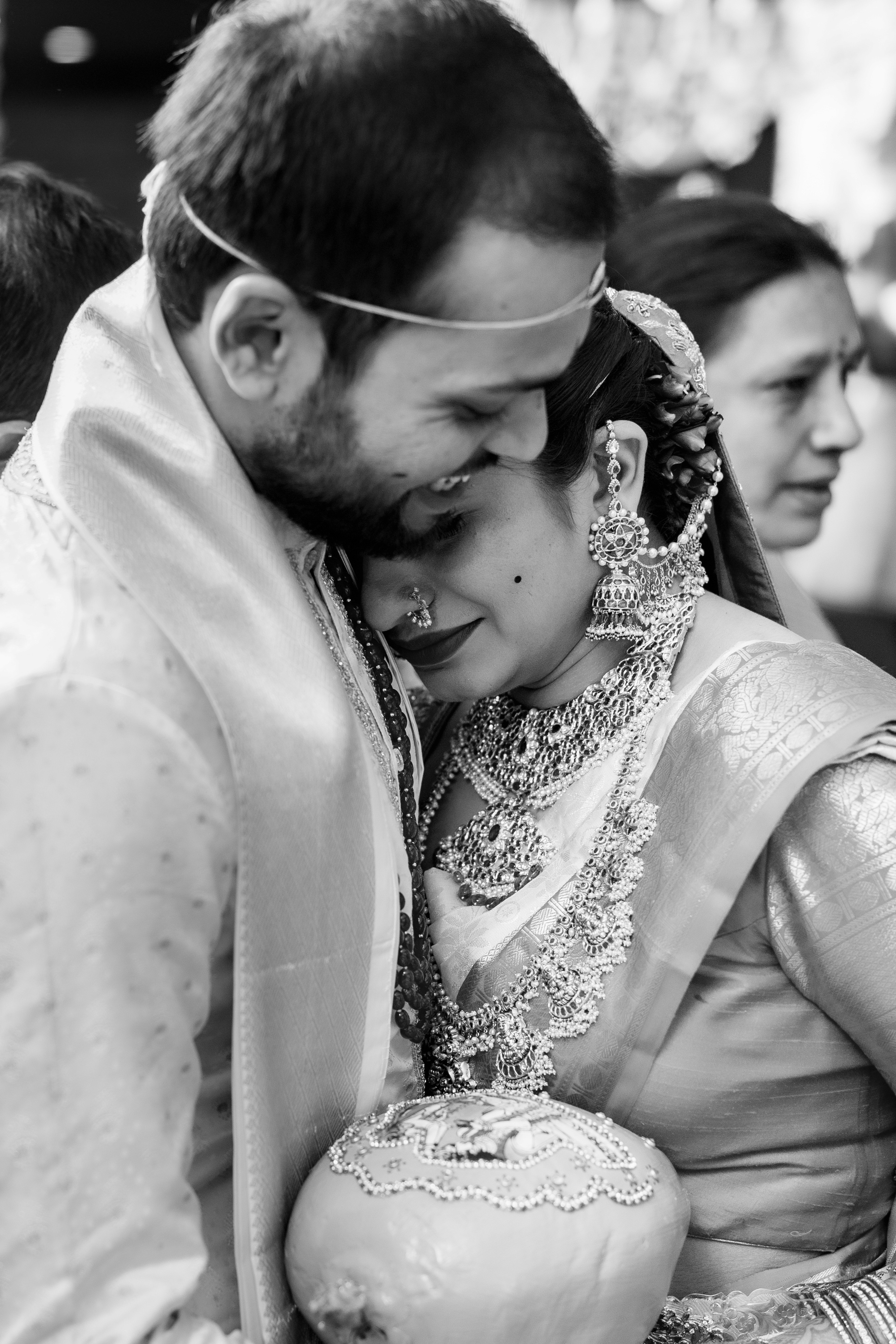 Mounika and Satya hugging at their wedding. Black & white Fine Art Wedding Photography in Hyderabad by Out of The Blues.