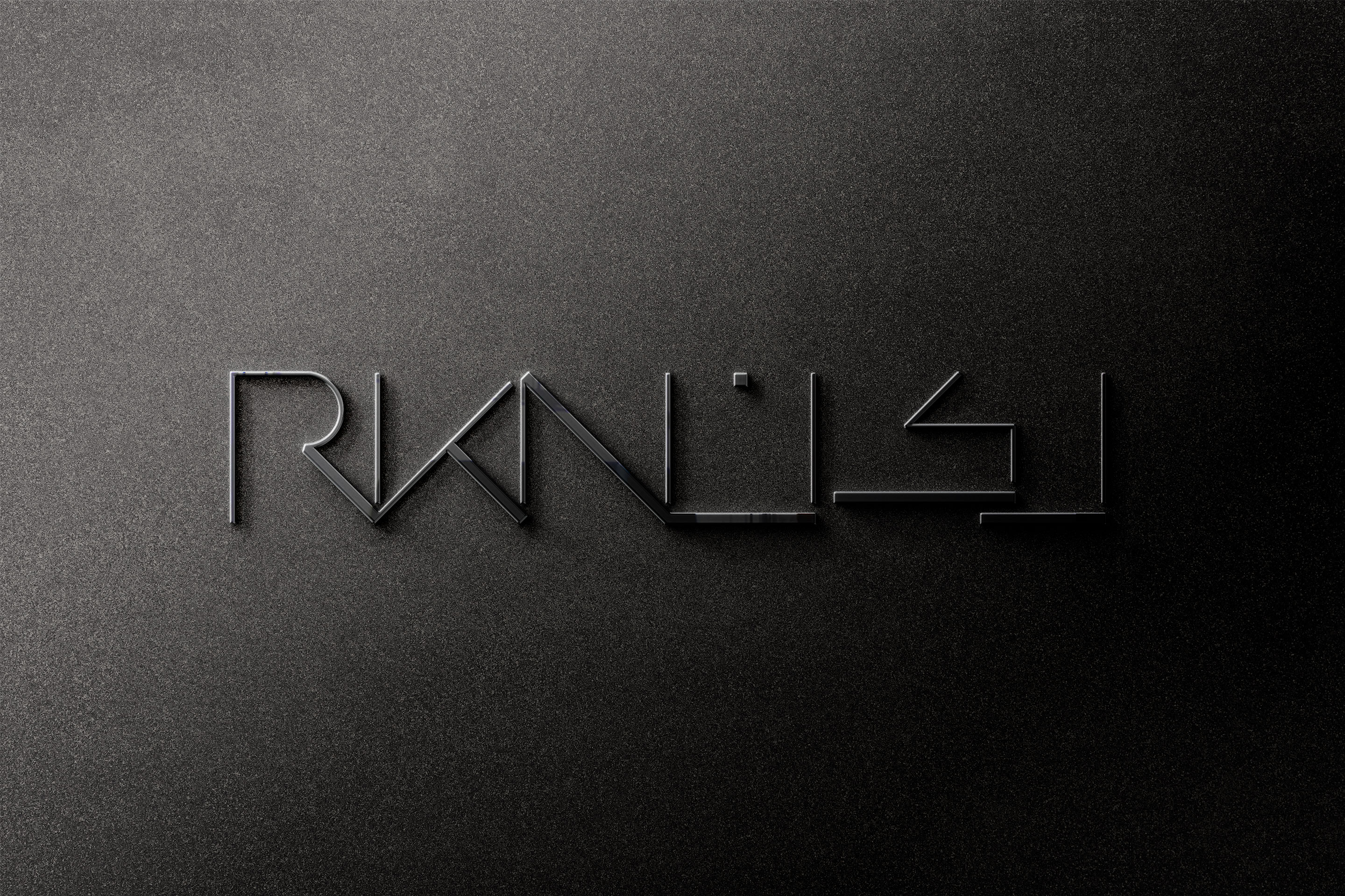 The RKN logo embossed in glossy black-on-black, its mirrored Latin-and-Arabic wordmark catching the light.