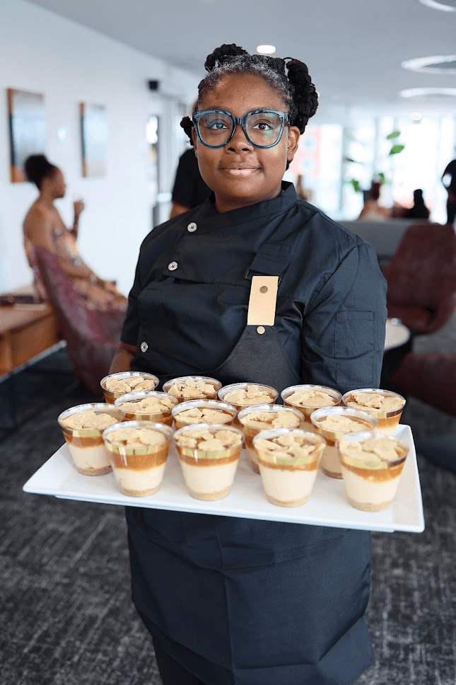 Chef serving plated appetizers at event