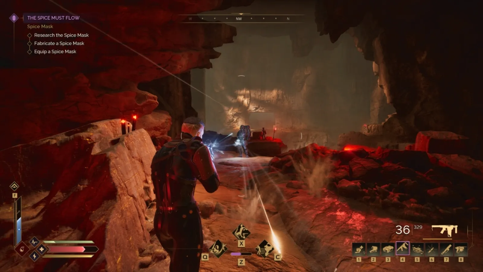 A person navigates a dimly lit, rocky cavern while engaging in a strategic gunfight, with glowing red lights from the environment and interface elements illuminating the scene in an action-packed video game setting.