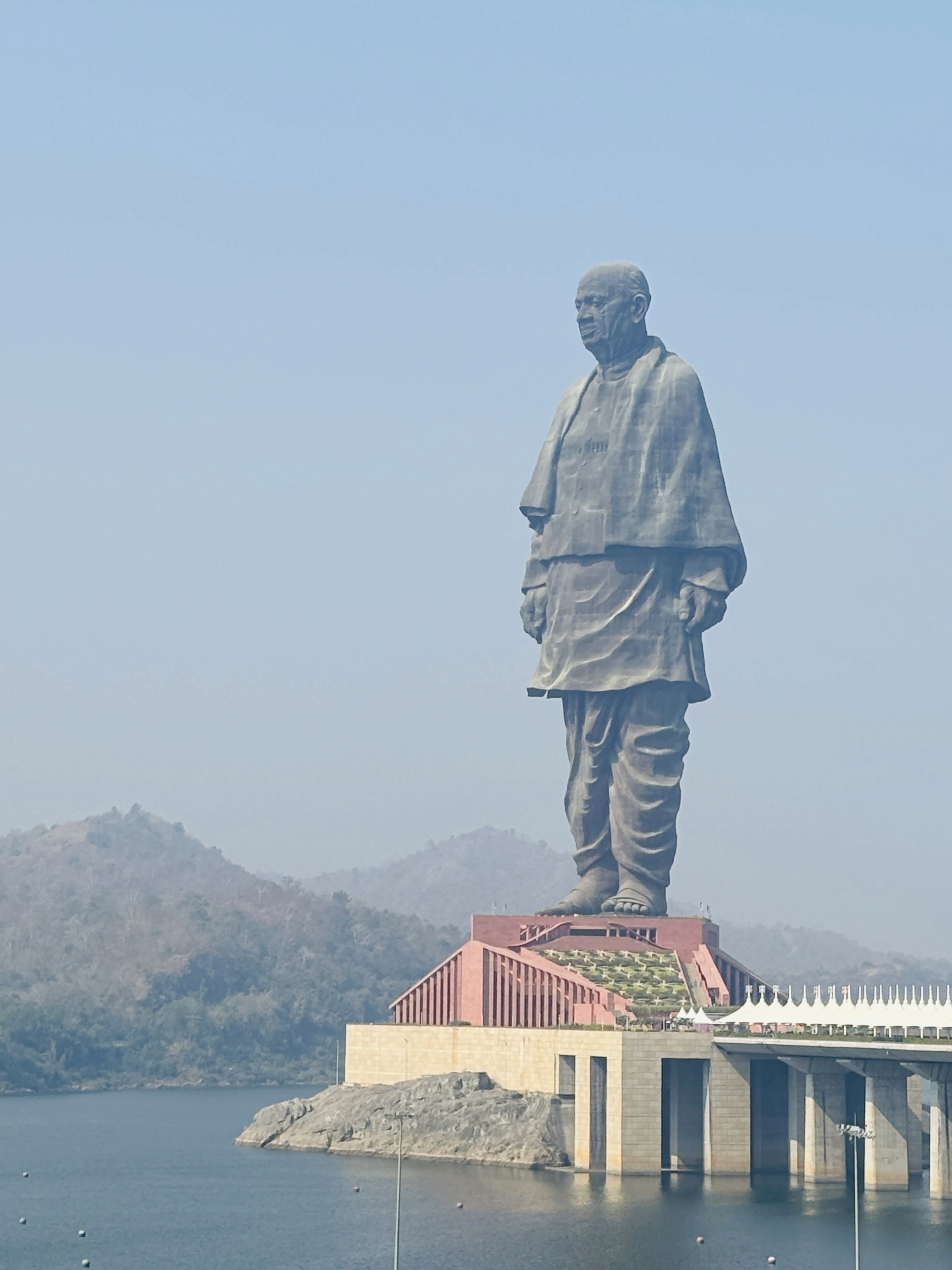 a group of people standing on top of a sandy beach