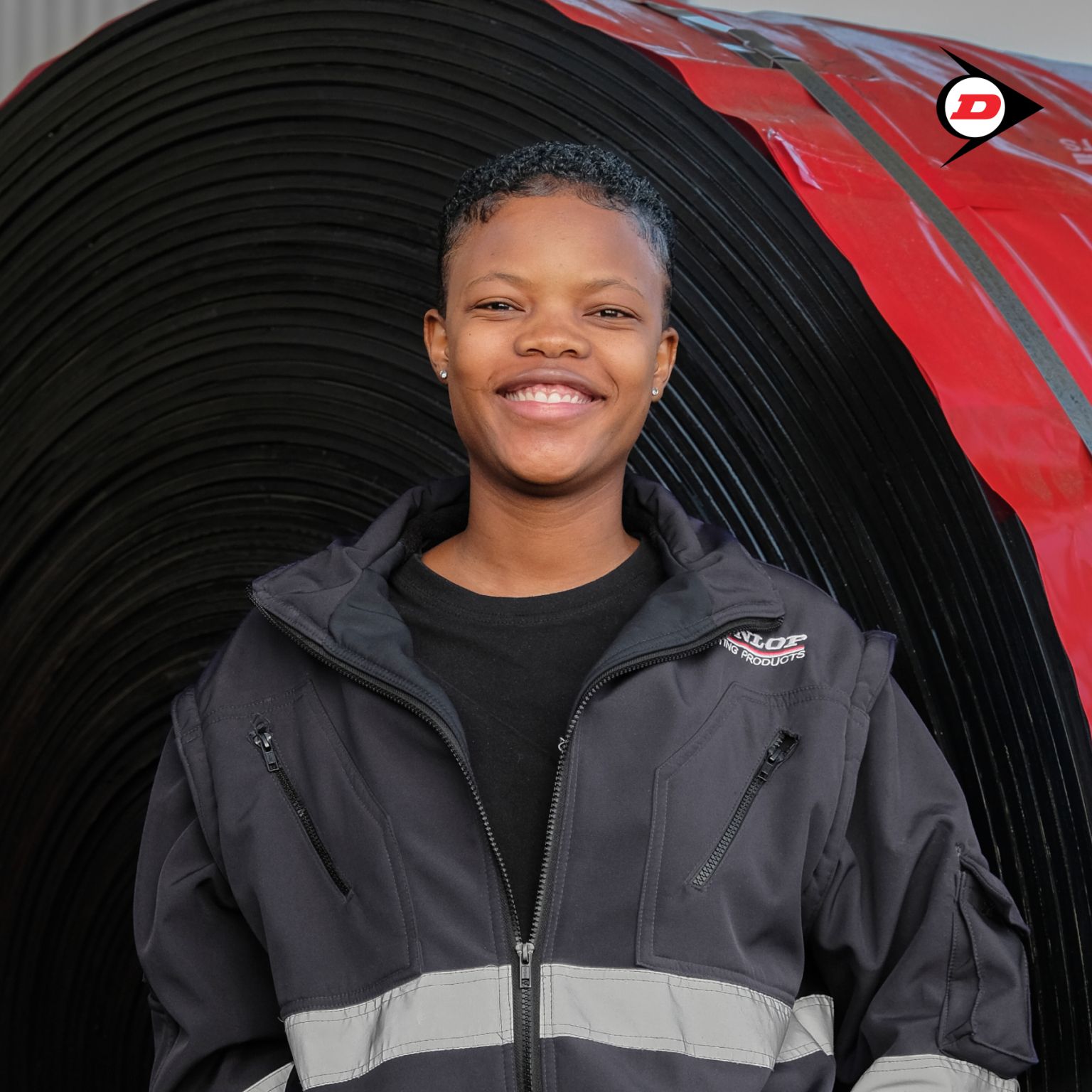 Close-up of a dark green leaf showing its textured surface and central vein against a muted background.