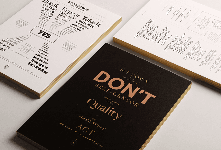 Three books are displayed on a white surface. The book on the left is white with black text and features the word "YES" prominently. The center book is black with gold text reading "SIT DOWN AND DO THE WORK" and "DON'T SELF-CENSOR". The book on the right is white with black text and includes phrases like "STRUGGLING TO Achieve Perfection Causes Nothing But Stress and Anxiety."
