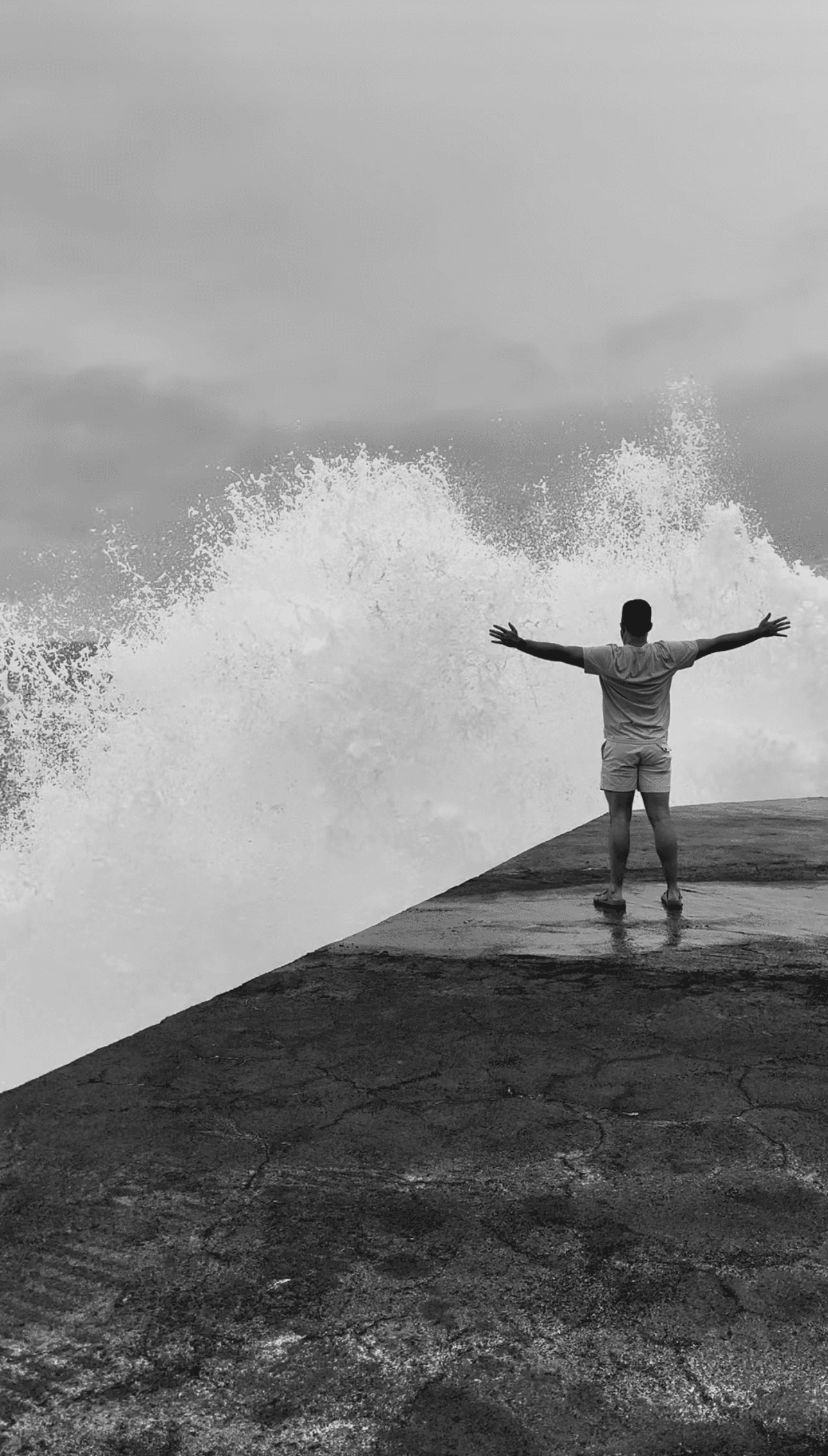 A large group photo of diverse team members gathered in an industrial-style space with arched ceiling.