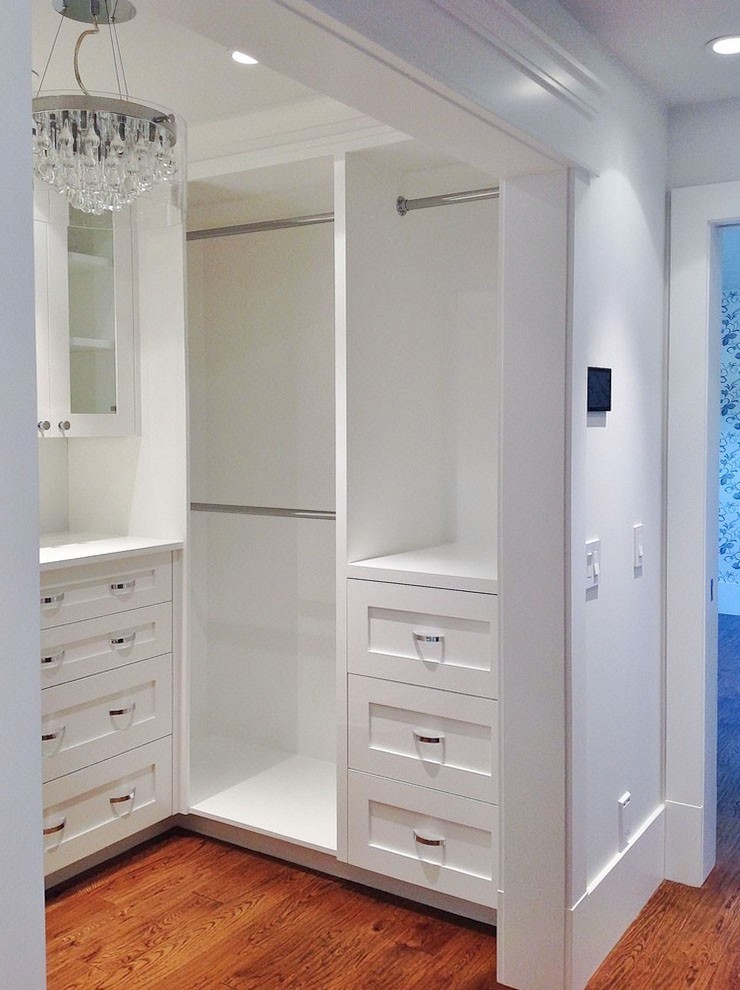 Image of Luxury primary ensuite closet design with custom drawers, shelves, and window coverings by KHD Homes.