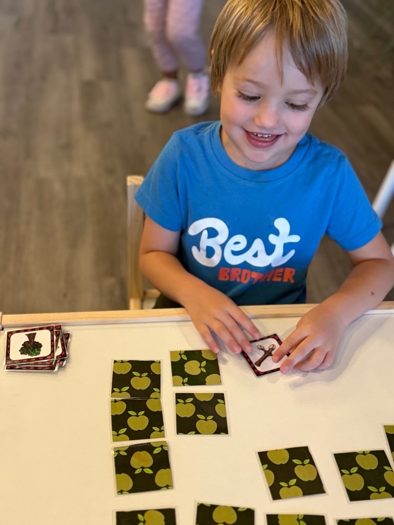 a child is drawing on a piece of paper