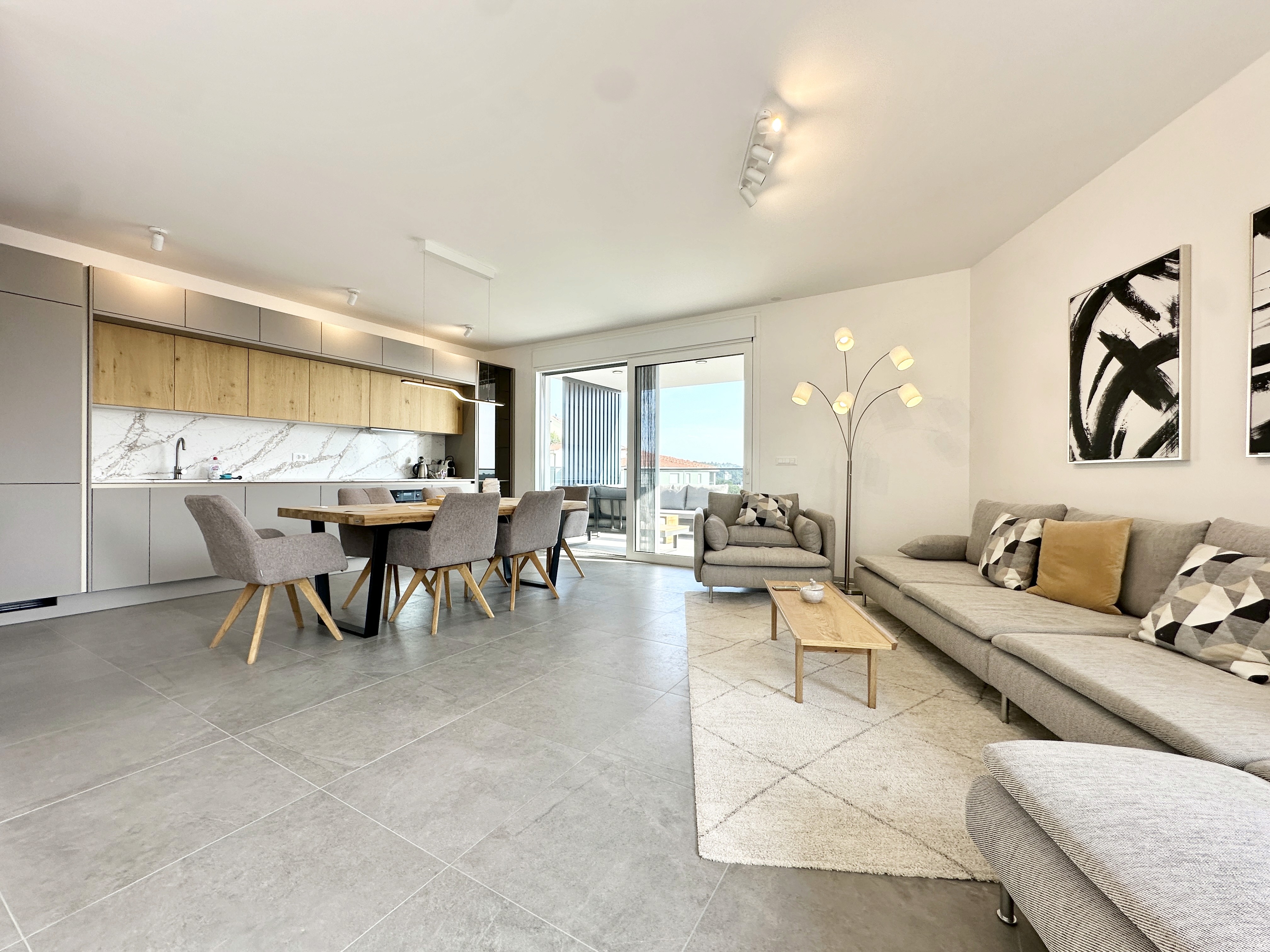 Black sports car in front of a modern, futuristic curved building.