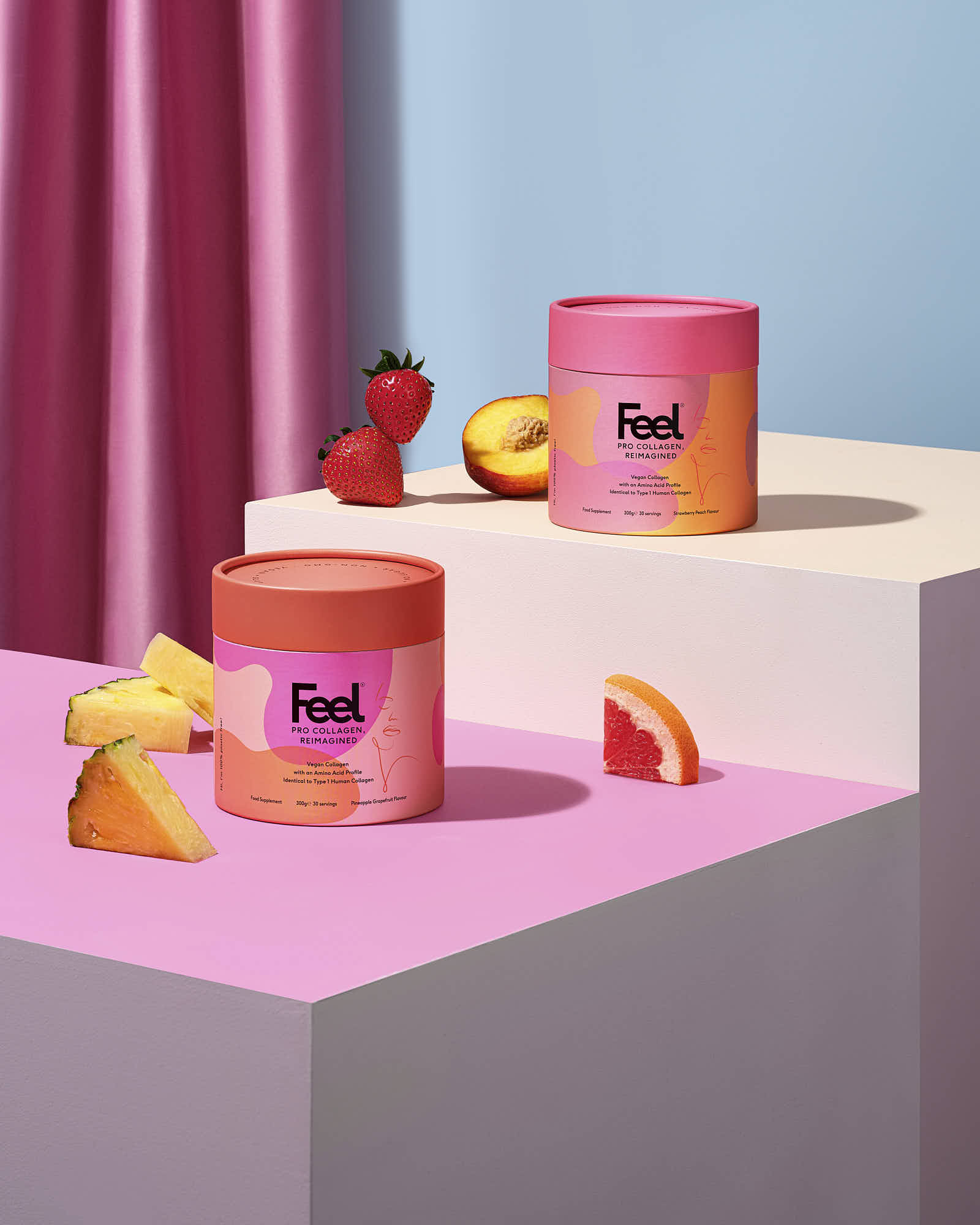 Two colorful jars sit on a pink platform, surrounded by fruit-shaped decorations against a backdrop of pastel colors.