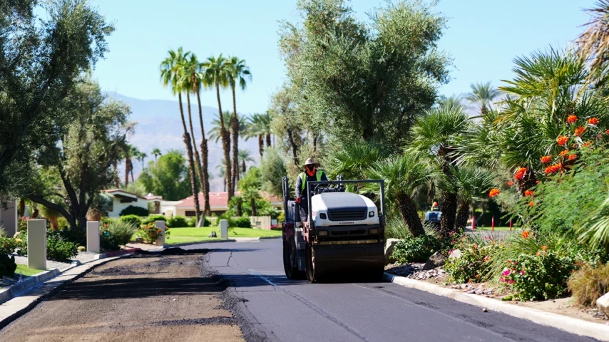 Roller compacting freshly paved asphalt street
