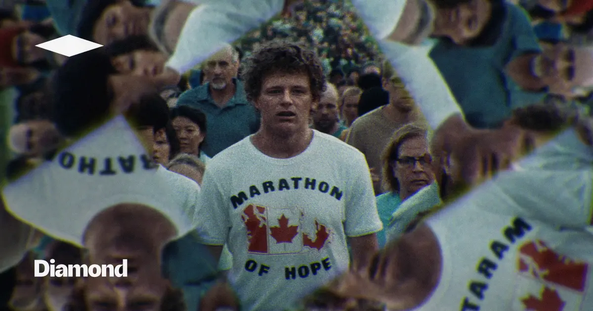 Man in Marathon of Hope shirt walking through a crowd with mirrored faces surrounding him