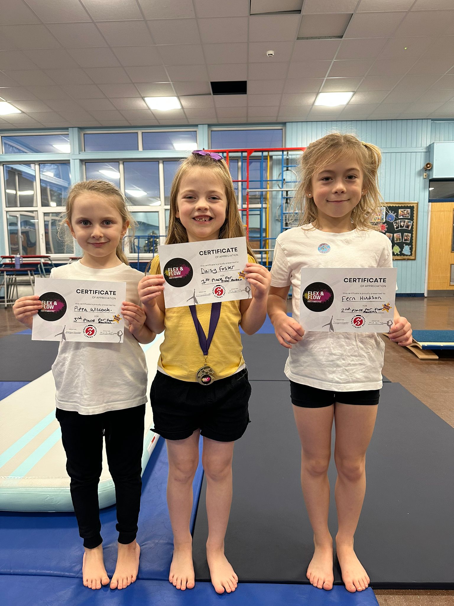 boy in blue white and red plaid button up shirt smiling