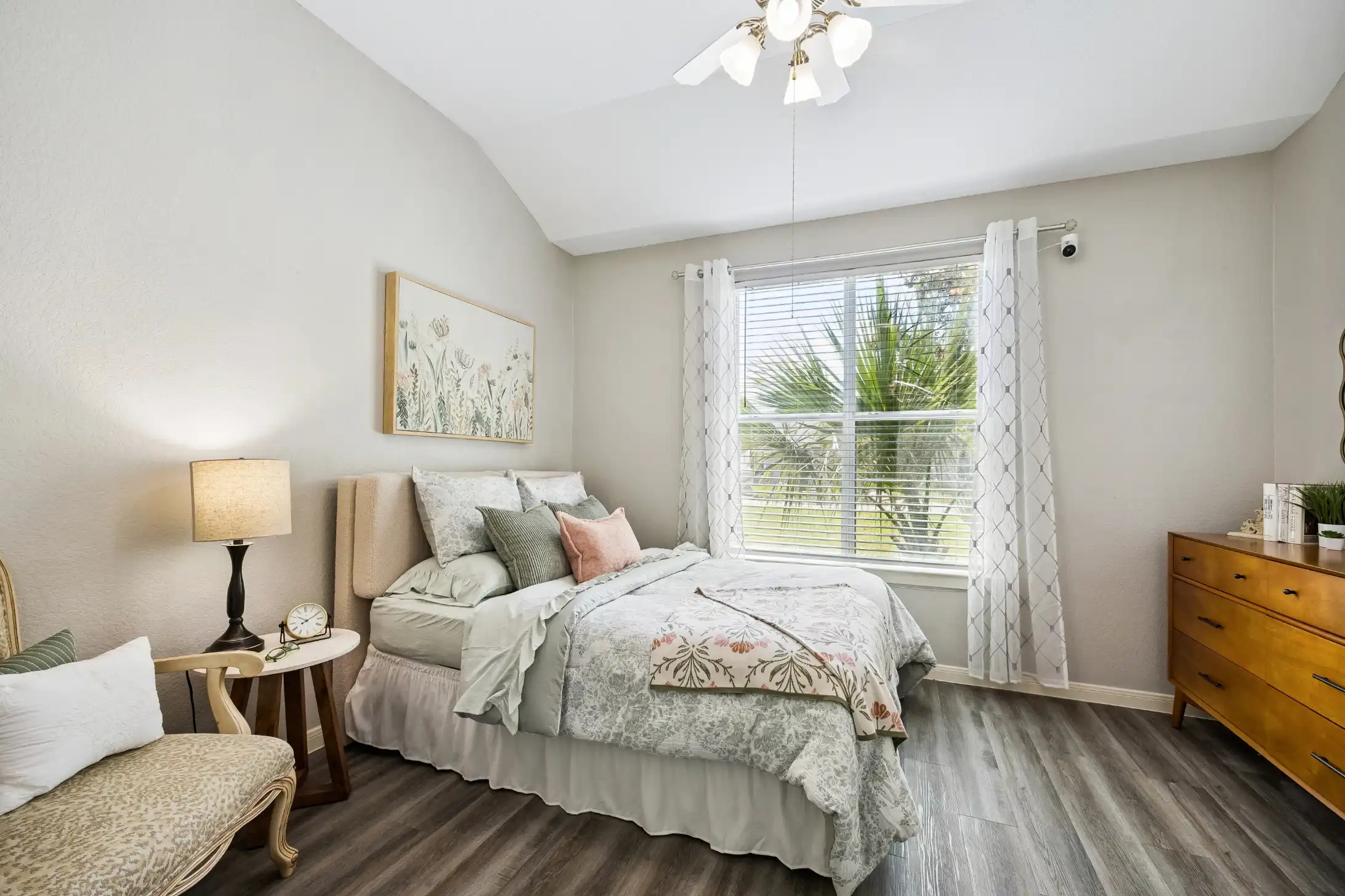 Cozy bedroom with upholstered bed and large window