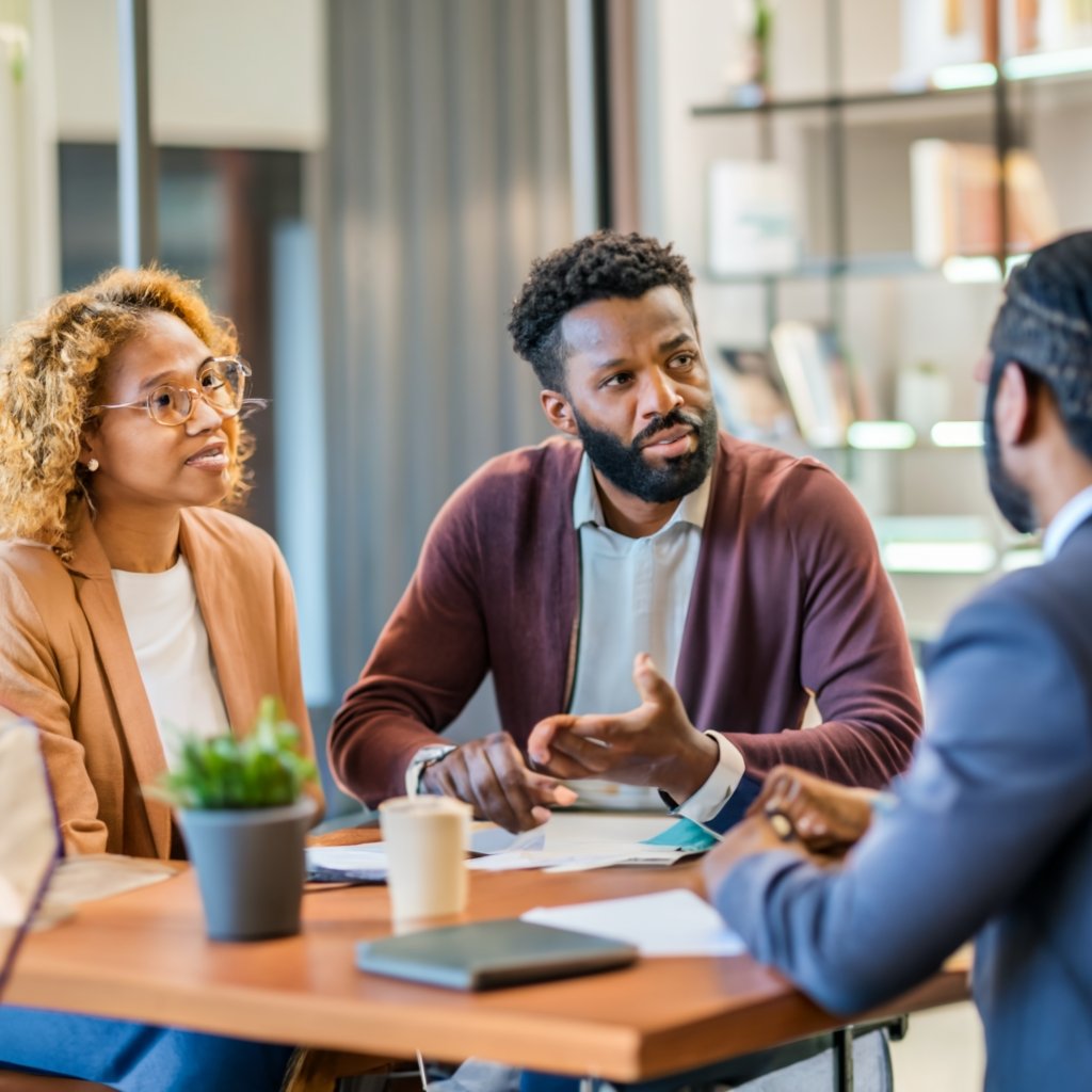 A couple discussing paperwork with an immigration attorney