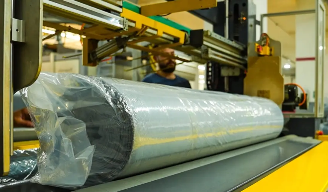 Fabric roll on conveyor.