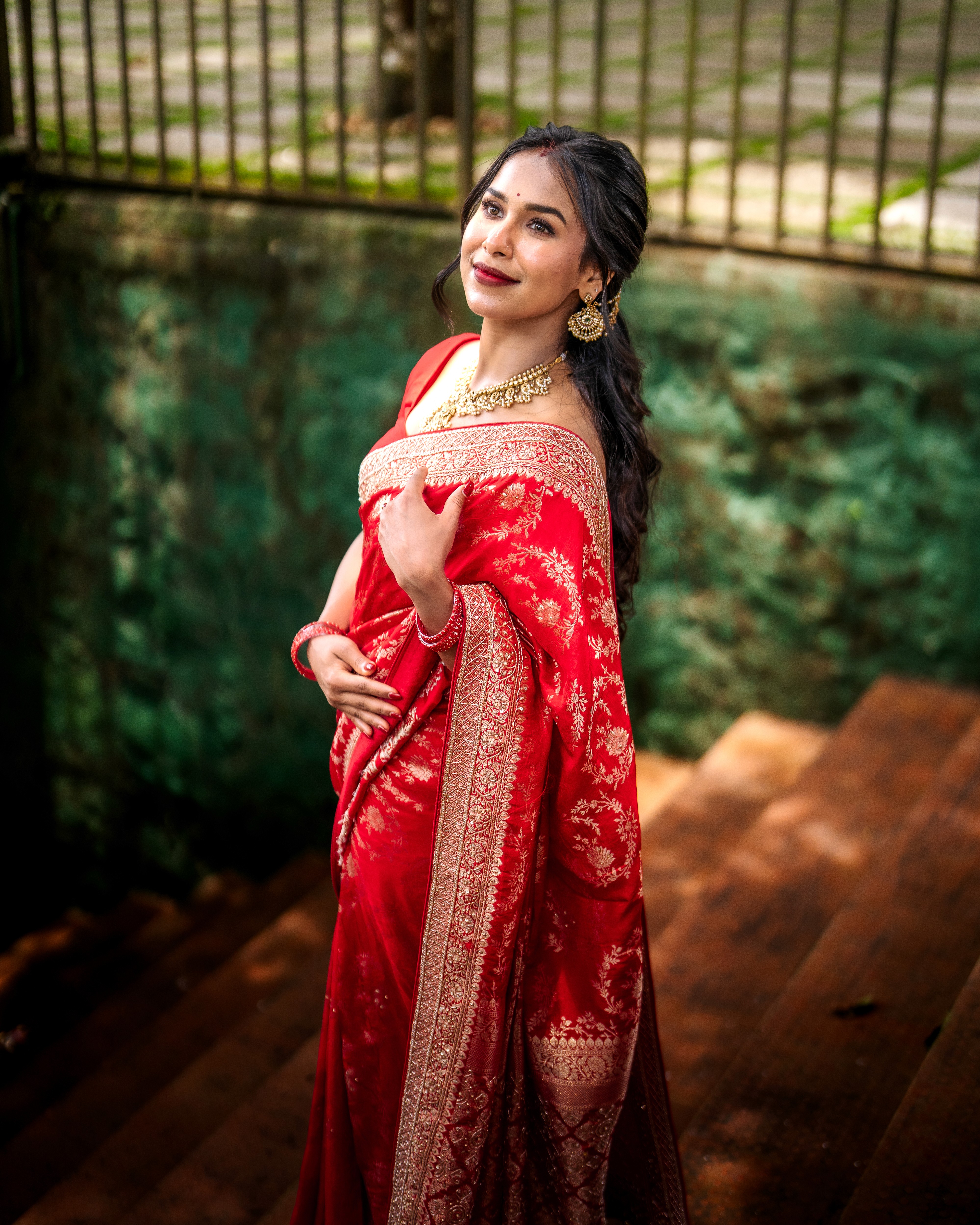 Palm trees and crowded beach with ocean in background.