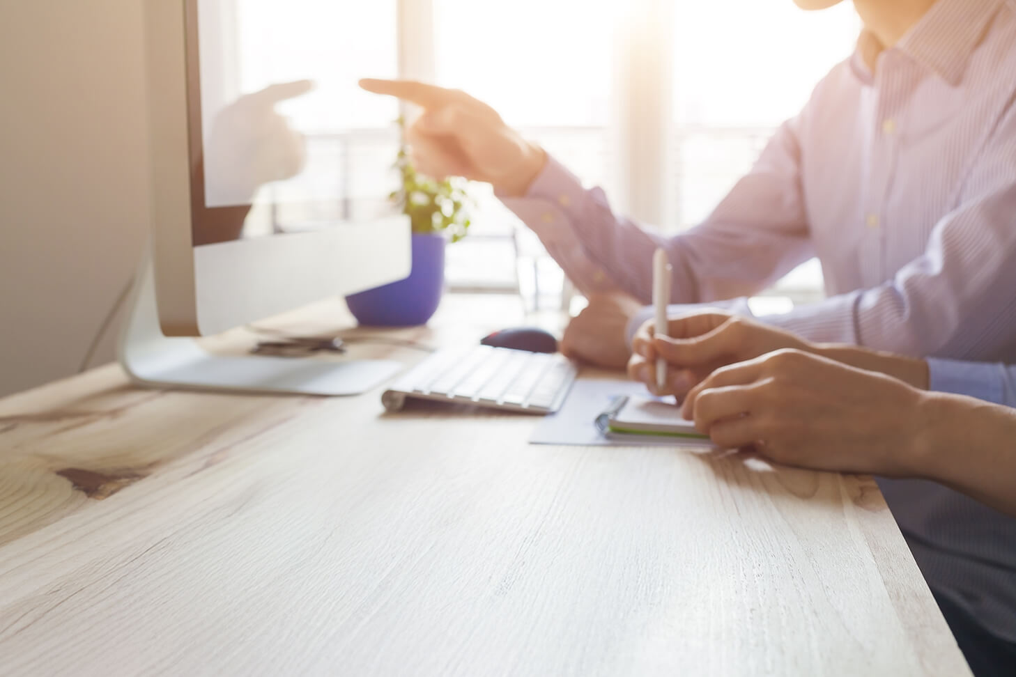 two people working at desk together