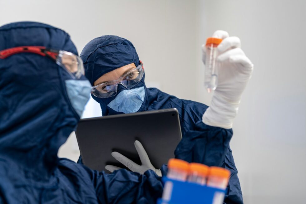 Image of two pharamacy techs in a sterile clean room