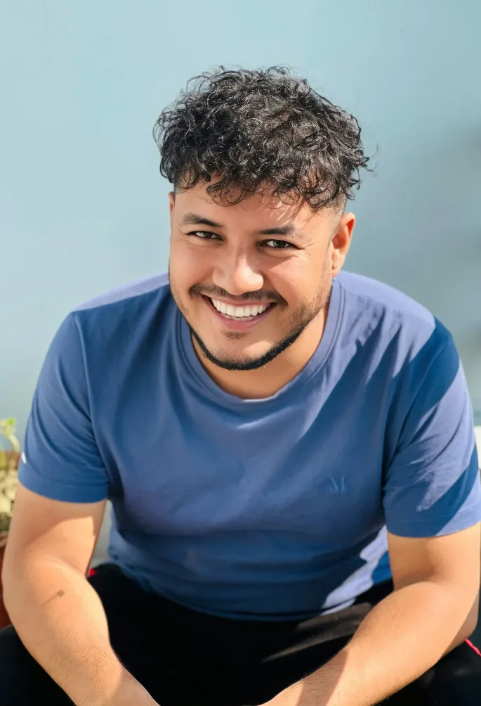 A man sitting on a bench smiling at the camera