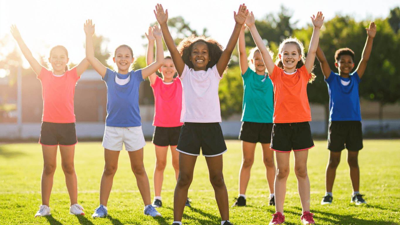 Group of Children Exercising Outdoors on Field