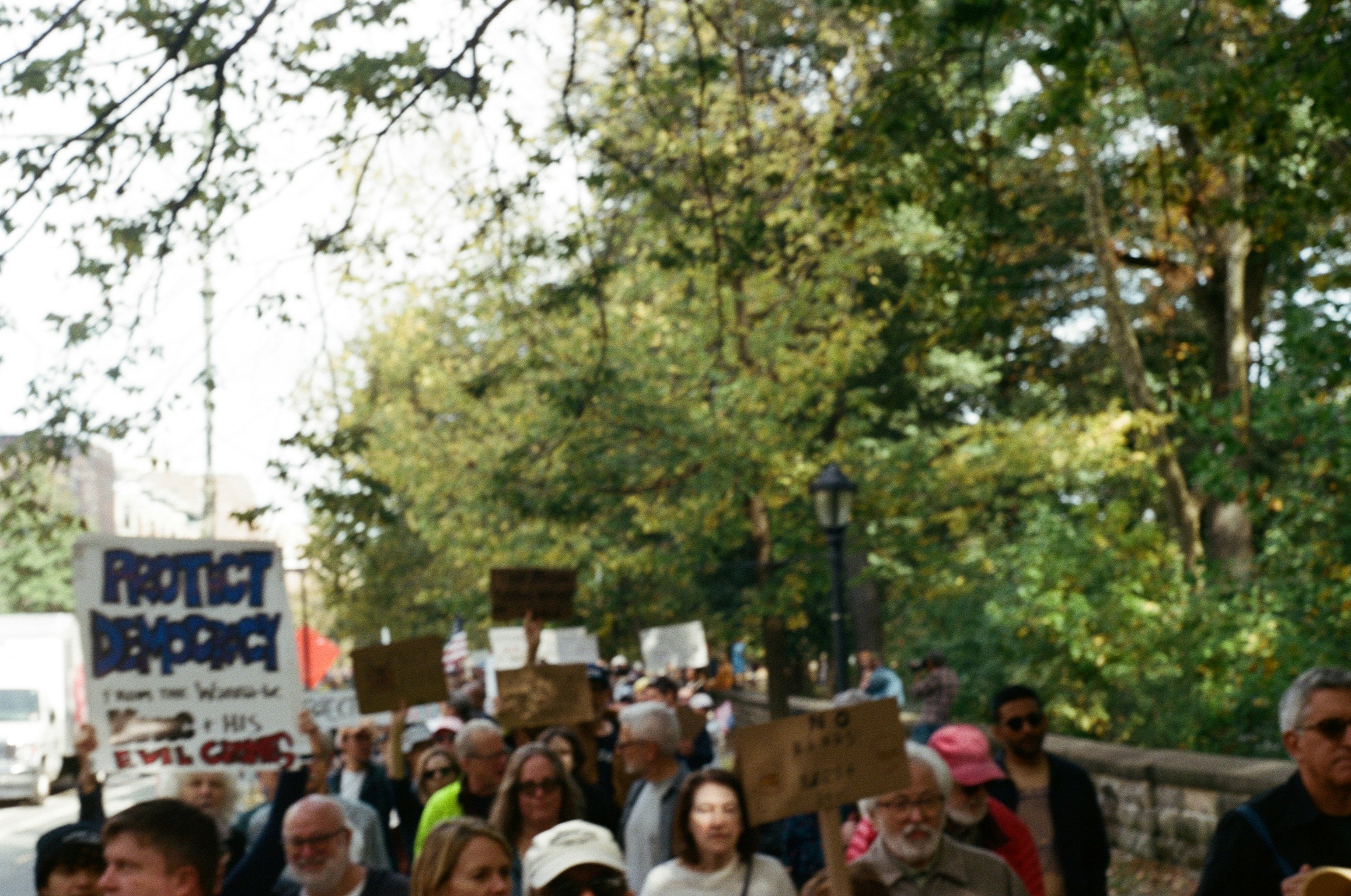 People marching with protest signs outdoors