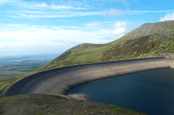 Aerial view of winding lake surrounded by dense forest