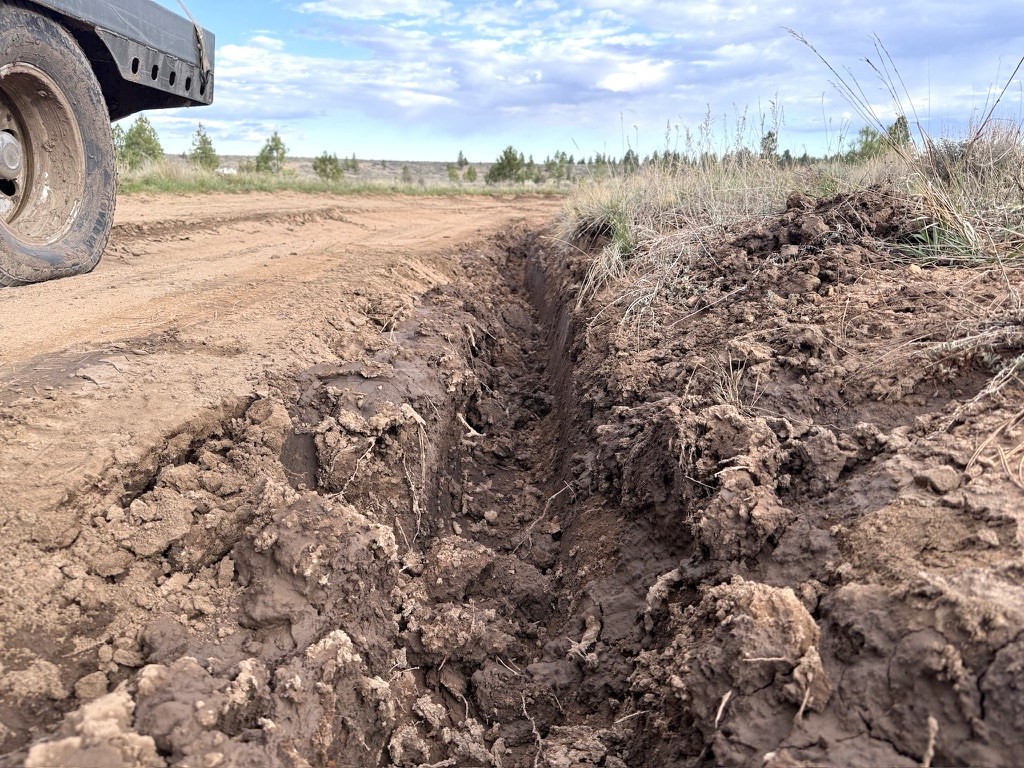 Mud ruts left behind after a fast-moving storm turned Tom's Best Road into a sinkhole