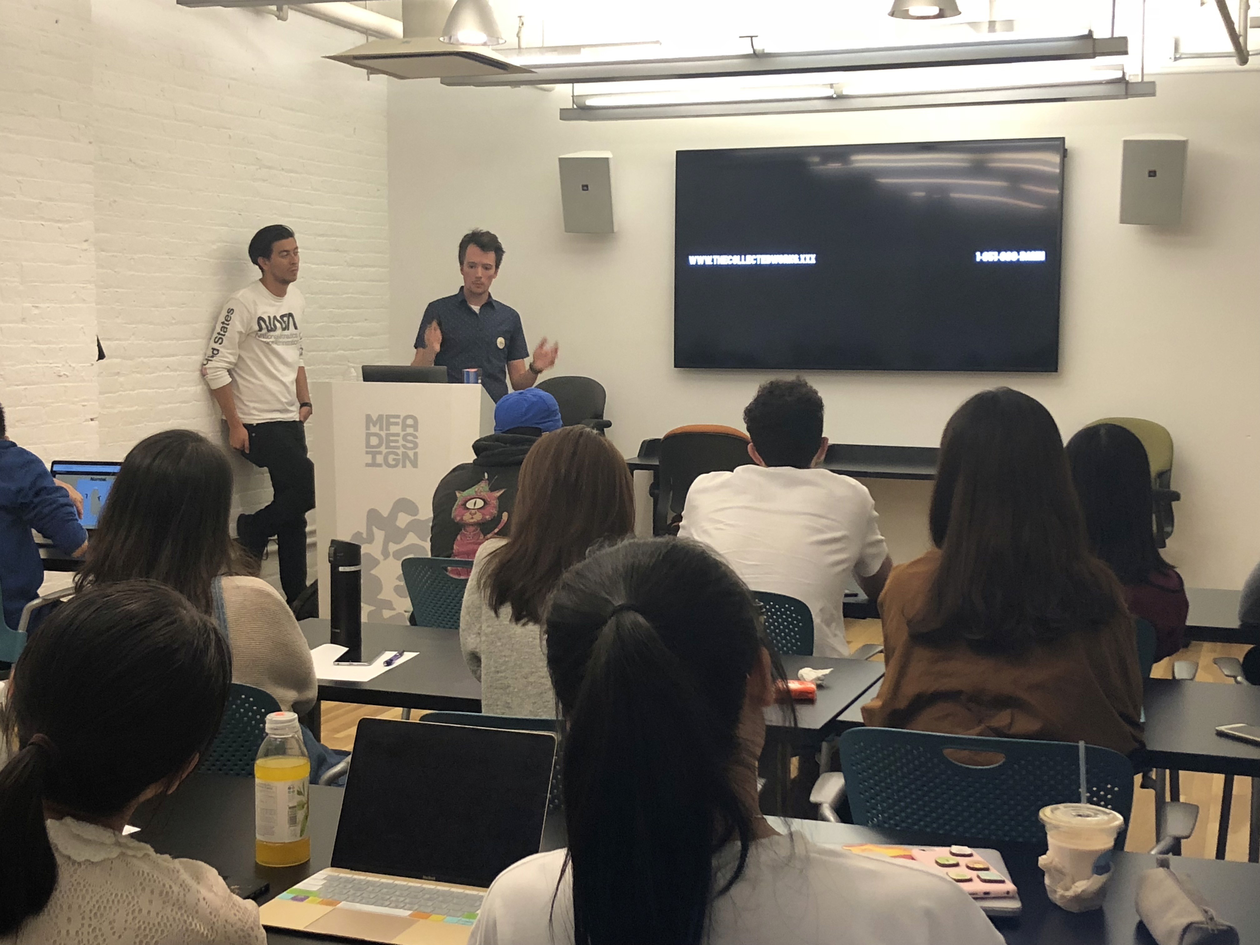 A photo of students in the classroom looking at a screen.