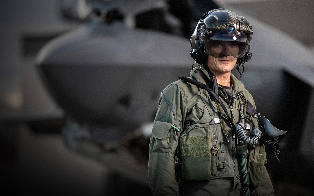 A sleek workspace featuring a laptop, tablet, and smartphone placed on a wooden desk, highlighting modern technology and connectivity.