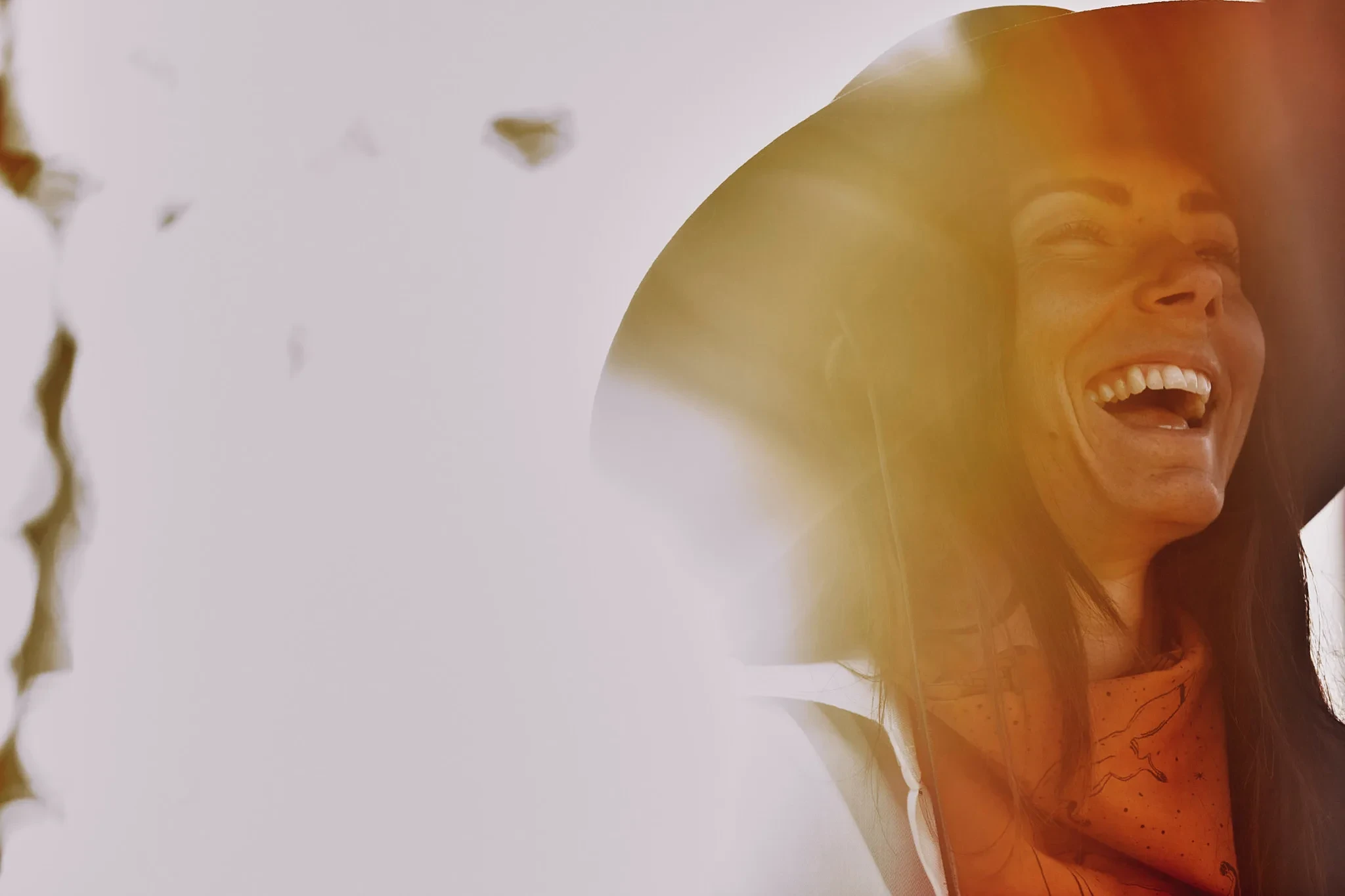 woman laughing head tilted back sunlight — Alex Saidac photography by Tom Kubik