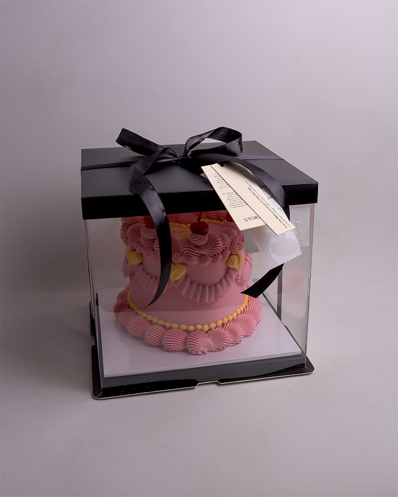 simple buttercream cake with raspberries arranged in a radial pattern for modern celebrations.