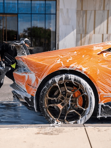 Detailed blue supercar with doors open.