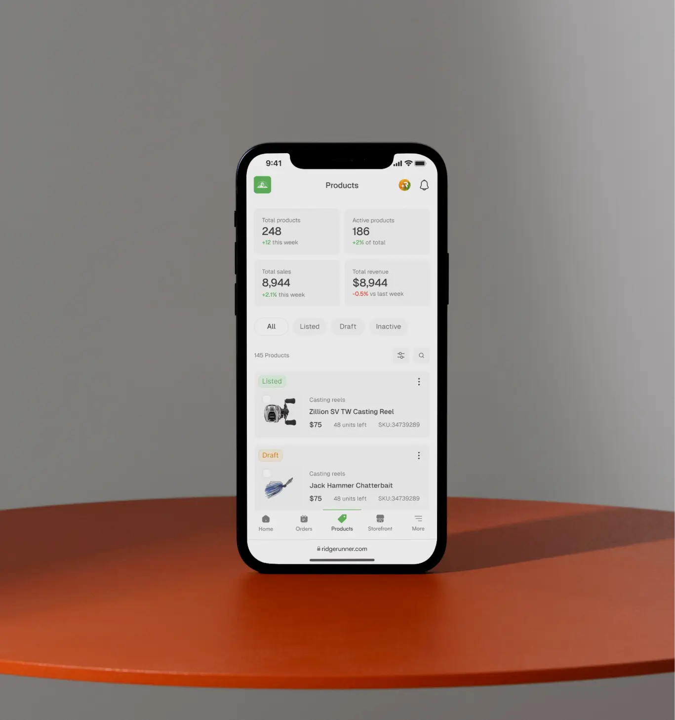 A phone standing on a table and showing a website interface