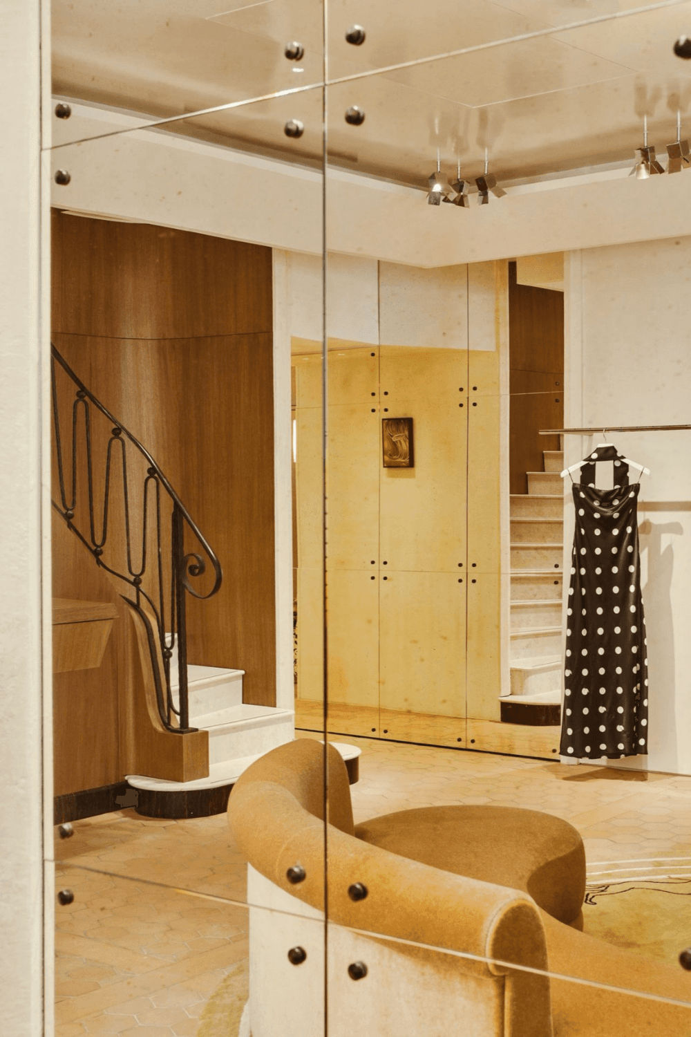 Person in a dark shirton a phone call, seated at a desk with papers, exudes a thoughtful, focused demeanor. Background shows dark horizontal blinds.