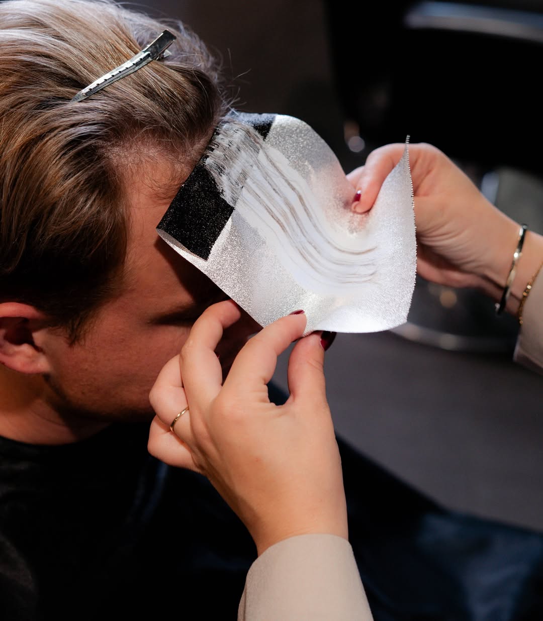 woman in wedding dress while holding flower during daytime