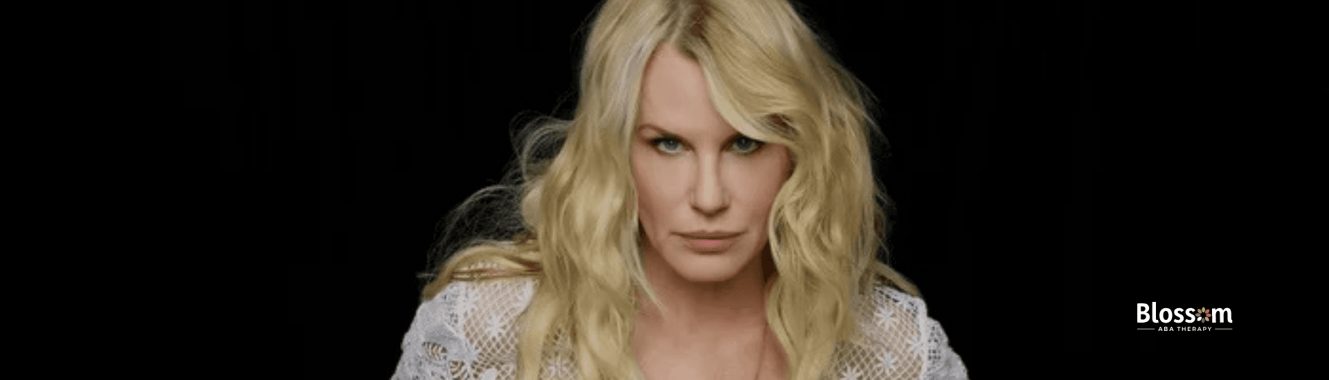 Daryl Hannah, diagnosed with autism, wearing lace top while posing confidently in Virginia.