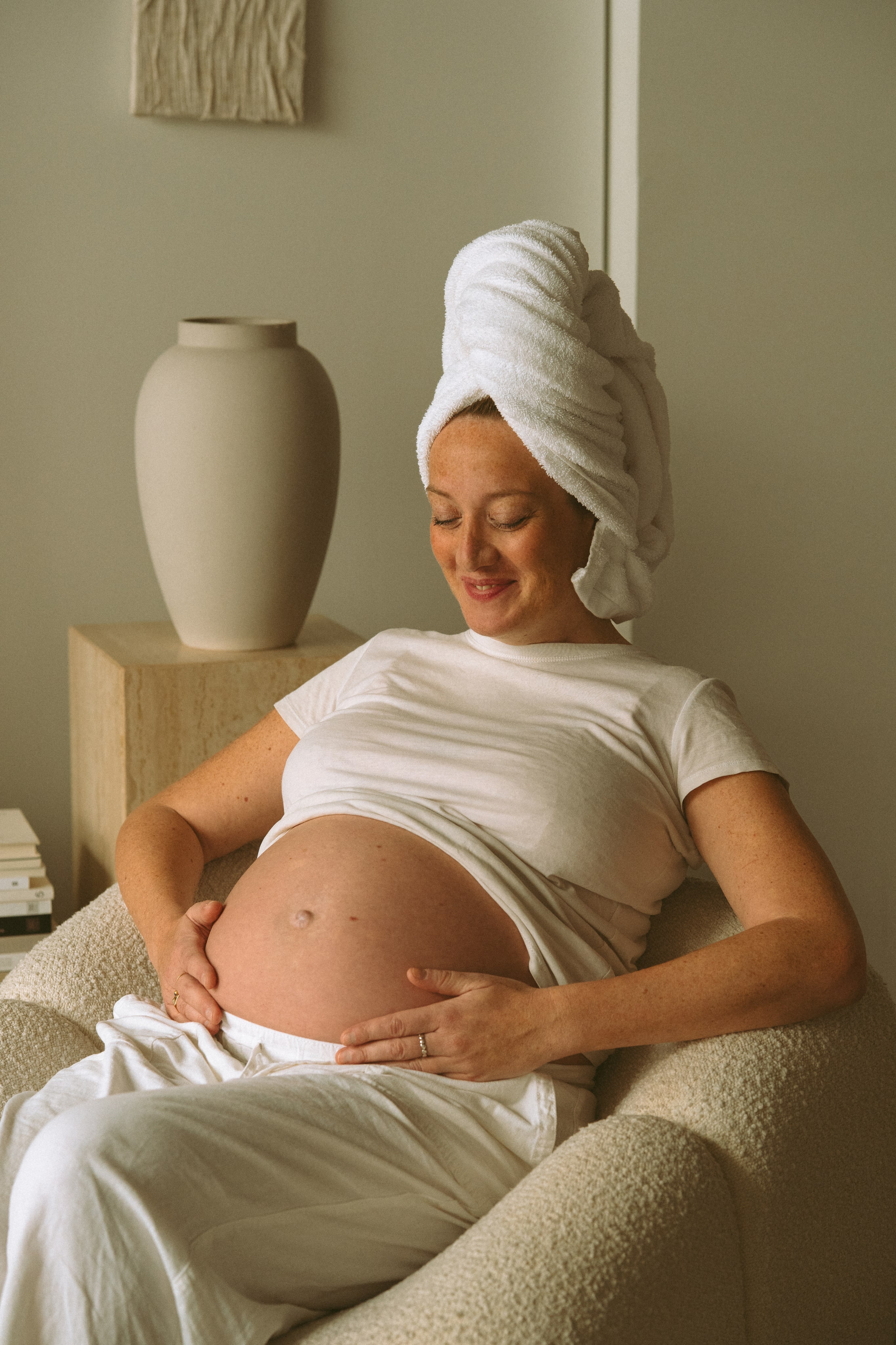 Pregnant woman lying comfortably while receiving a gentle spa treatment.