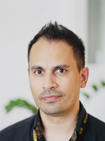 A portrait of a young man smiling