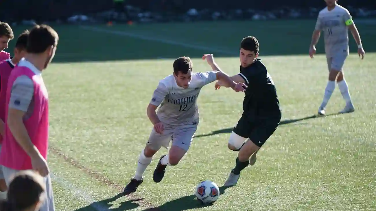 Amateur football players competing for the ball during a match, representing tournament sponsorship opportunities, local audiences and live sports engagement in amateur football.