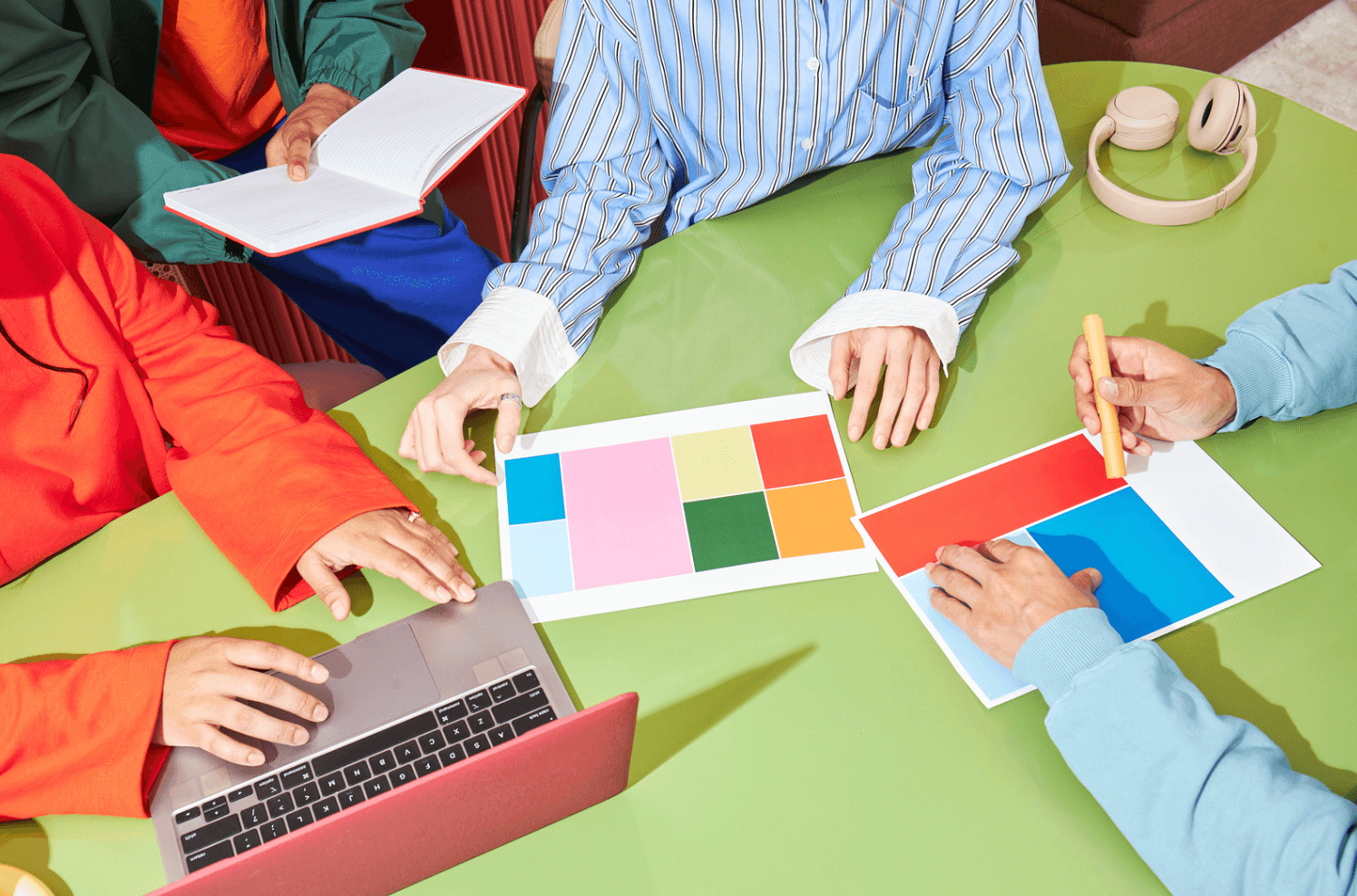 Team reviewing color palettes and design materials, illustrating creative refresh and seasonal updates for Amazon ad campaigns.