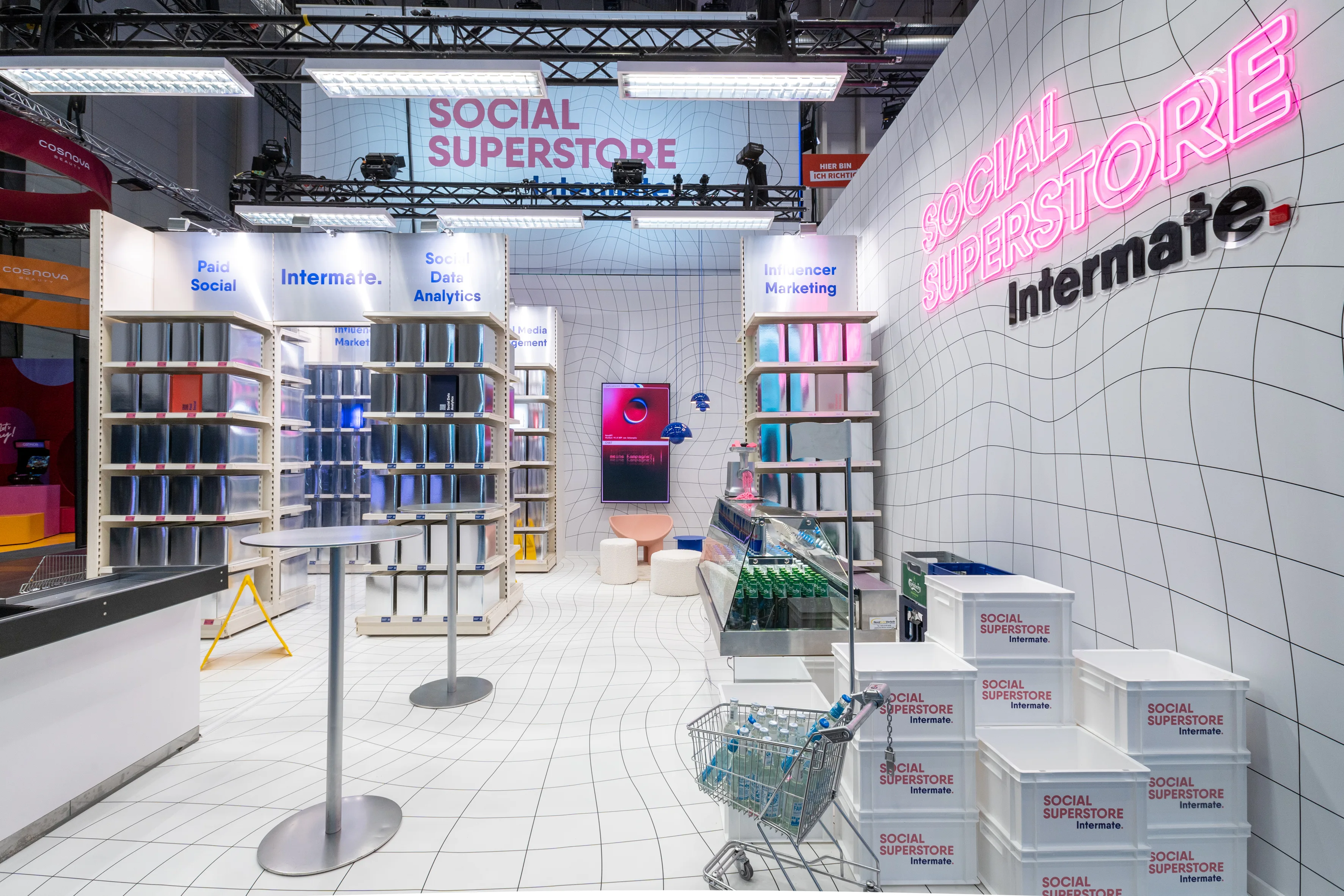 White Intermate Social Superstore with warped grid pattern, service shelves, shopping cart and stacked logo crates.