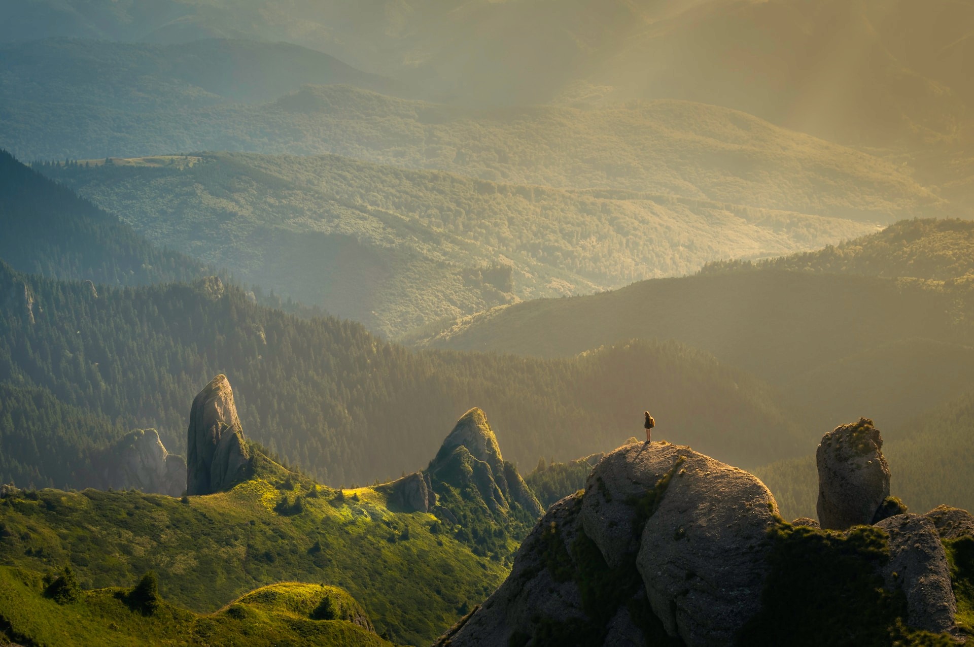 A scenic lanscape of person standing on a mountain
