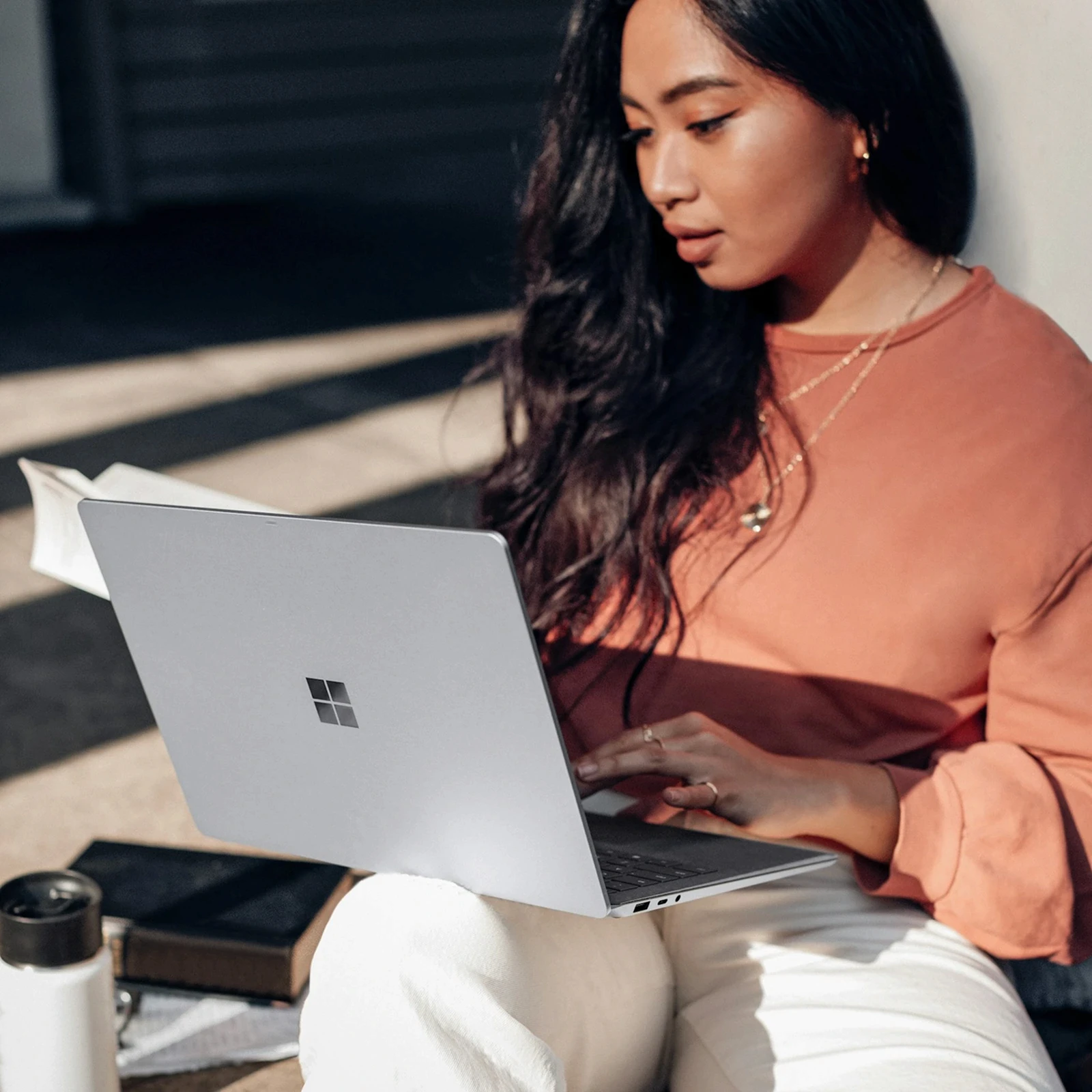 Woman working on a laptop with a payday notification showing a $4,182.60 payment