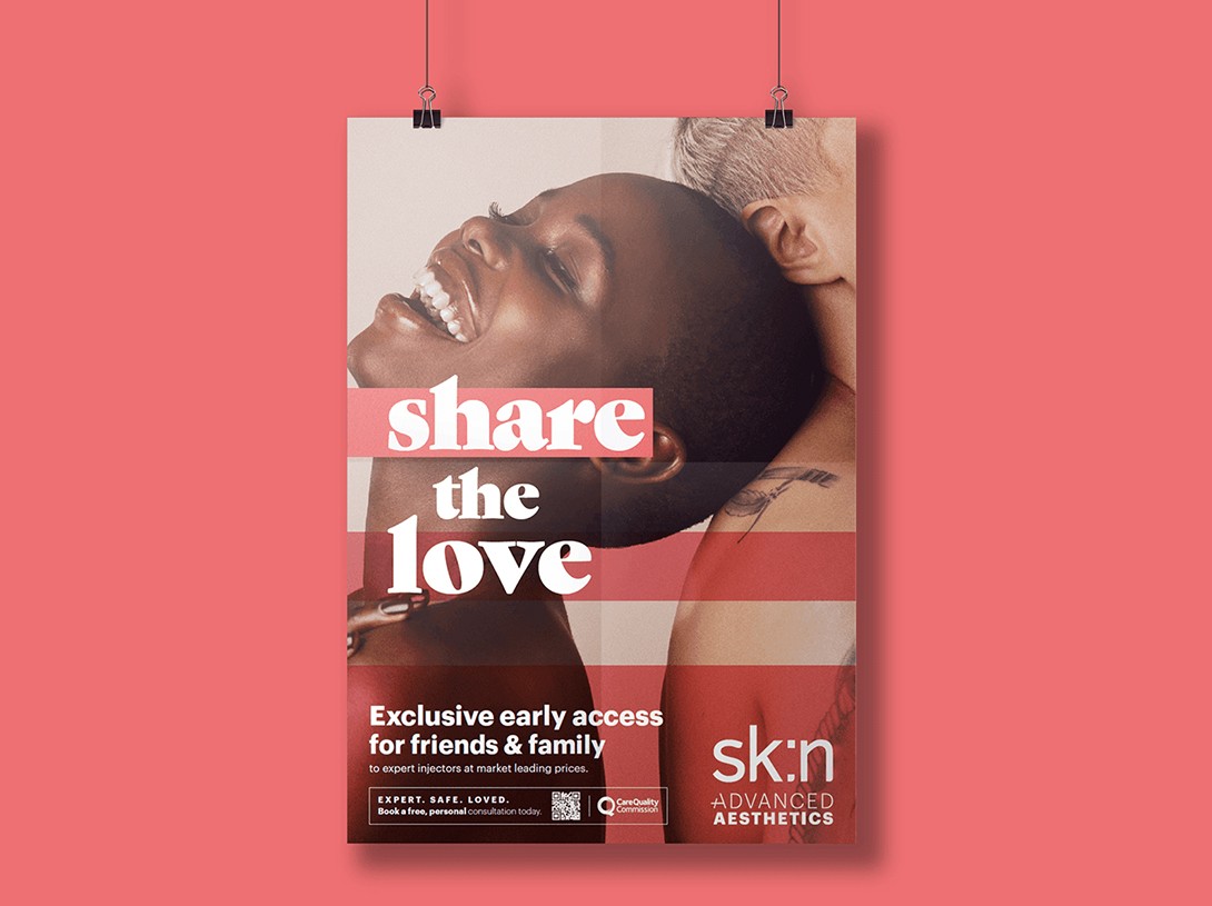 A close-up of a person wearing green-tinted glasses, with a serious expression and smooth skin.